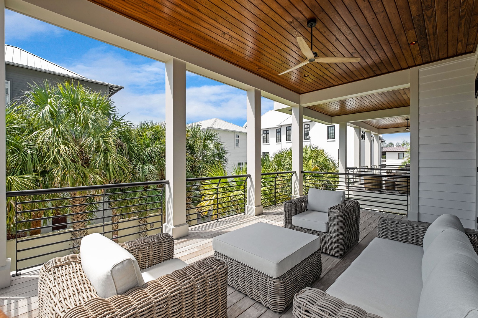 Unwind on your private covered terrace with comfortable seating while enjoying tropical palm views and gentle breezes overhead.