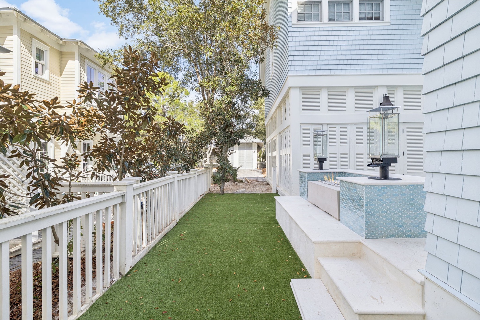 Your private outdoor oasis features a sparkling spa and pristine lawn, perfect for unwinding after exploring the coastal charm.
