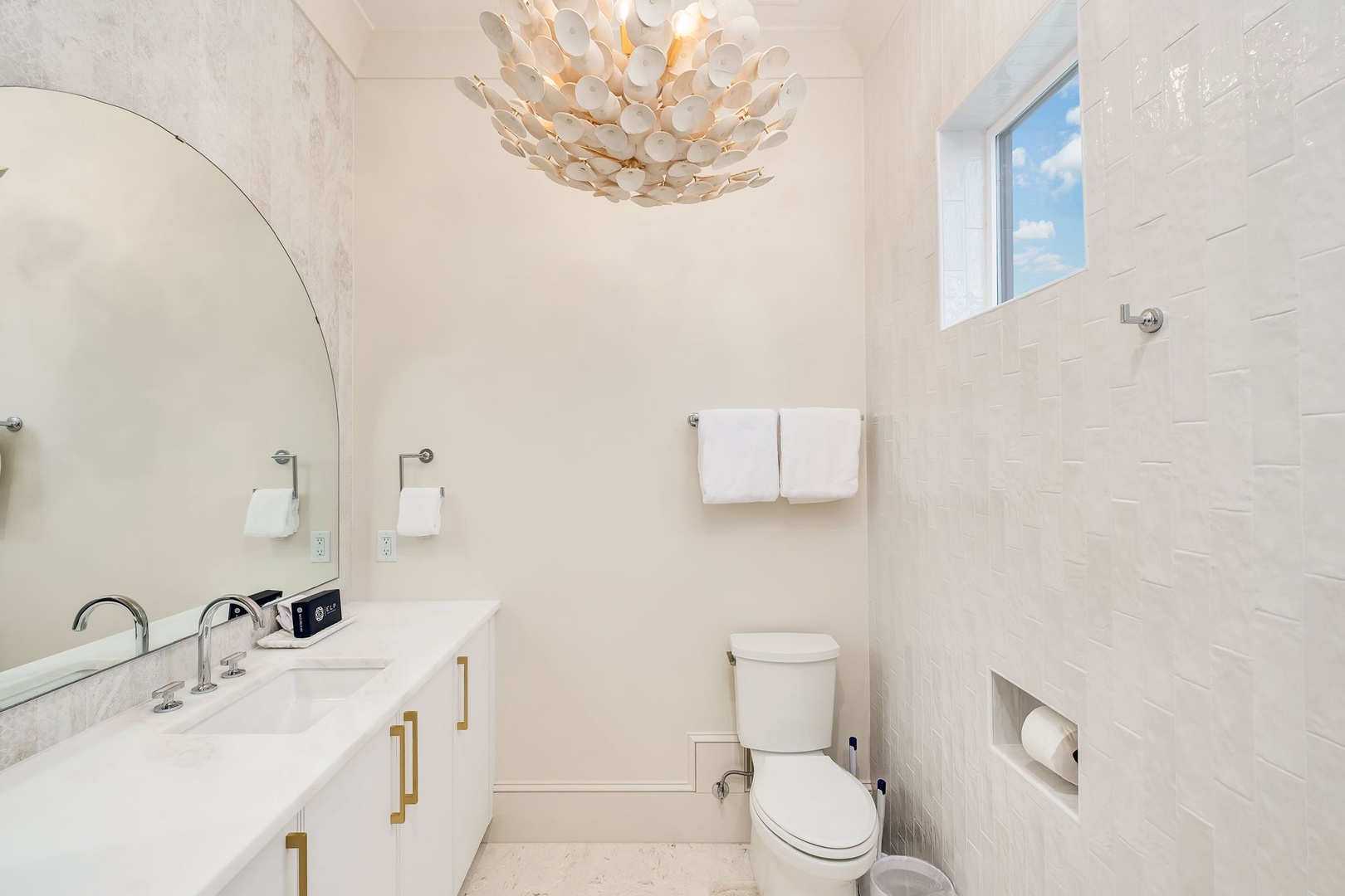 Freshen up in this bright, elegantly designed bathroom with a sleek vanity, chic lighting, and modern finishes that make your daily routine feel spa-like.