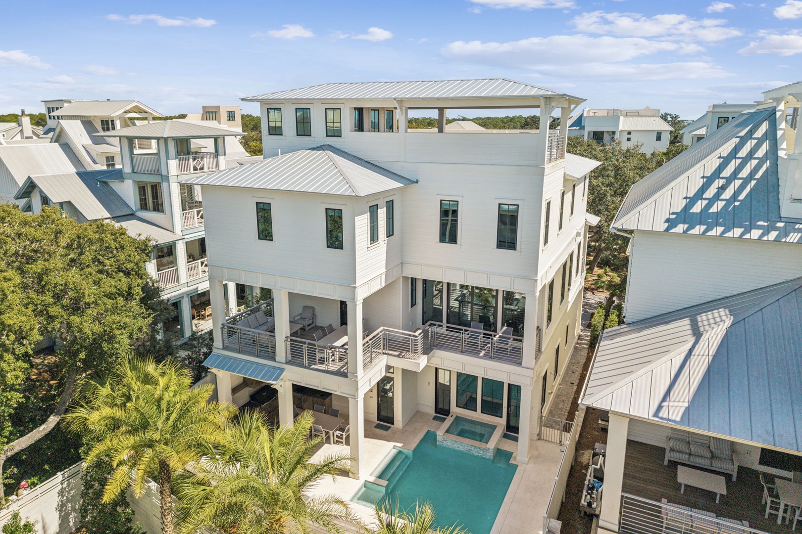 Modern coastal retreat featuring elevated design with private pool and multiple outdoor decks in a luxury neighborhood setting.