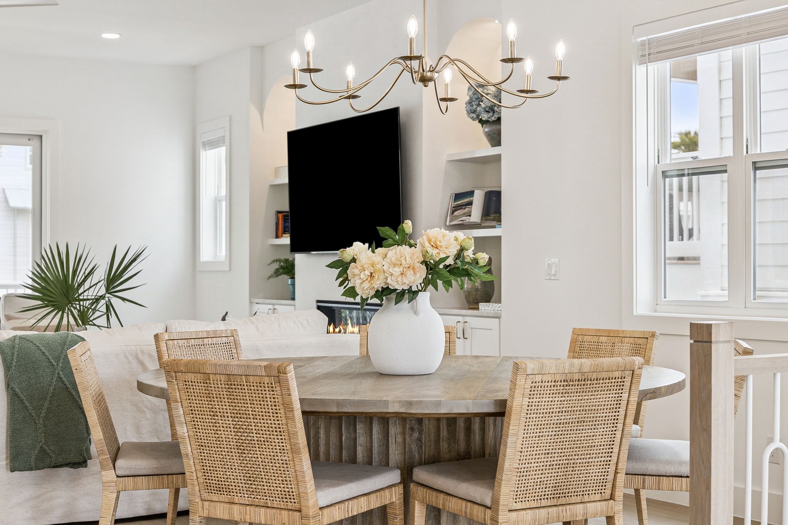 Your bright dining space features elegant wicker chairs and stunning chandelier, creating the perfect setting for memorable meals together.