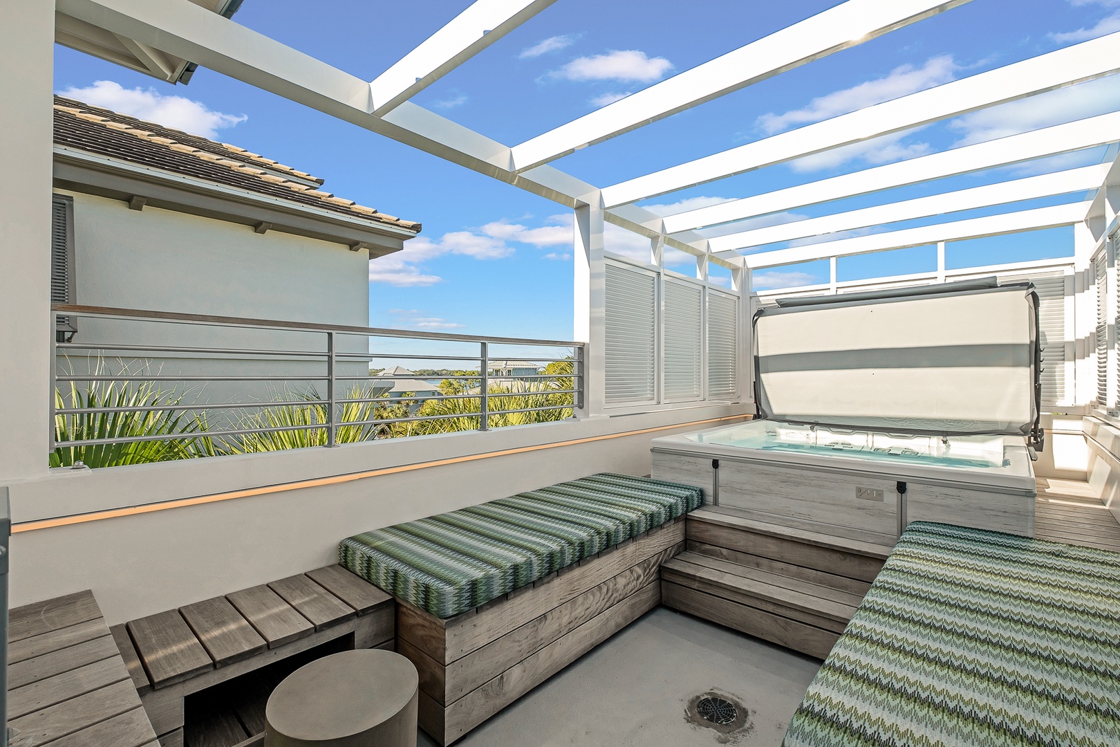 Soak in your private hot tub under the open sky, surrounded by comfortable seating for the perfect outdoor relaxation experience.