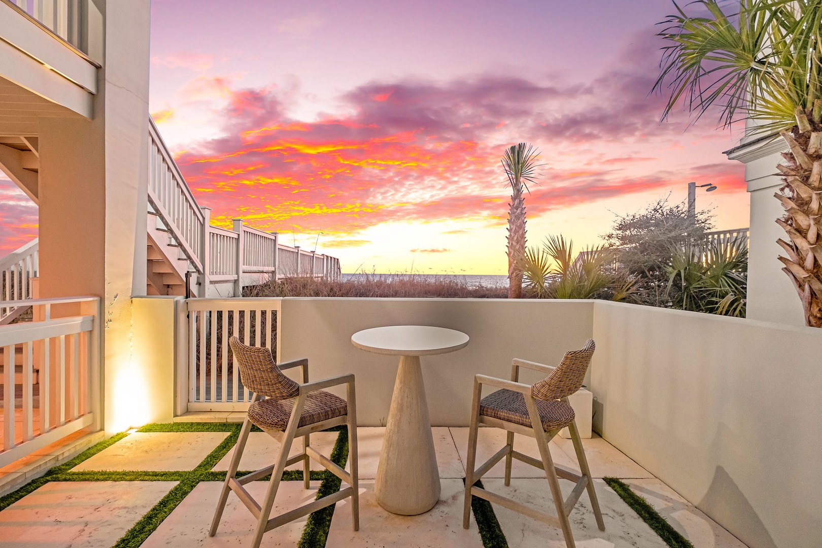 Private patio captures breathtaking sunset views over tropical landscaping, offering an intimate retreat for evening relaxation with coastal breezes and vibrant skies.