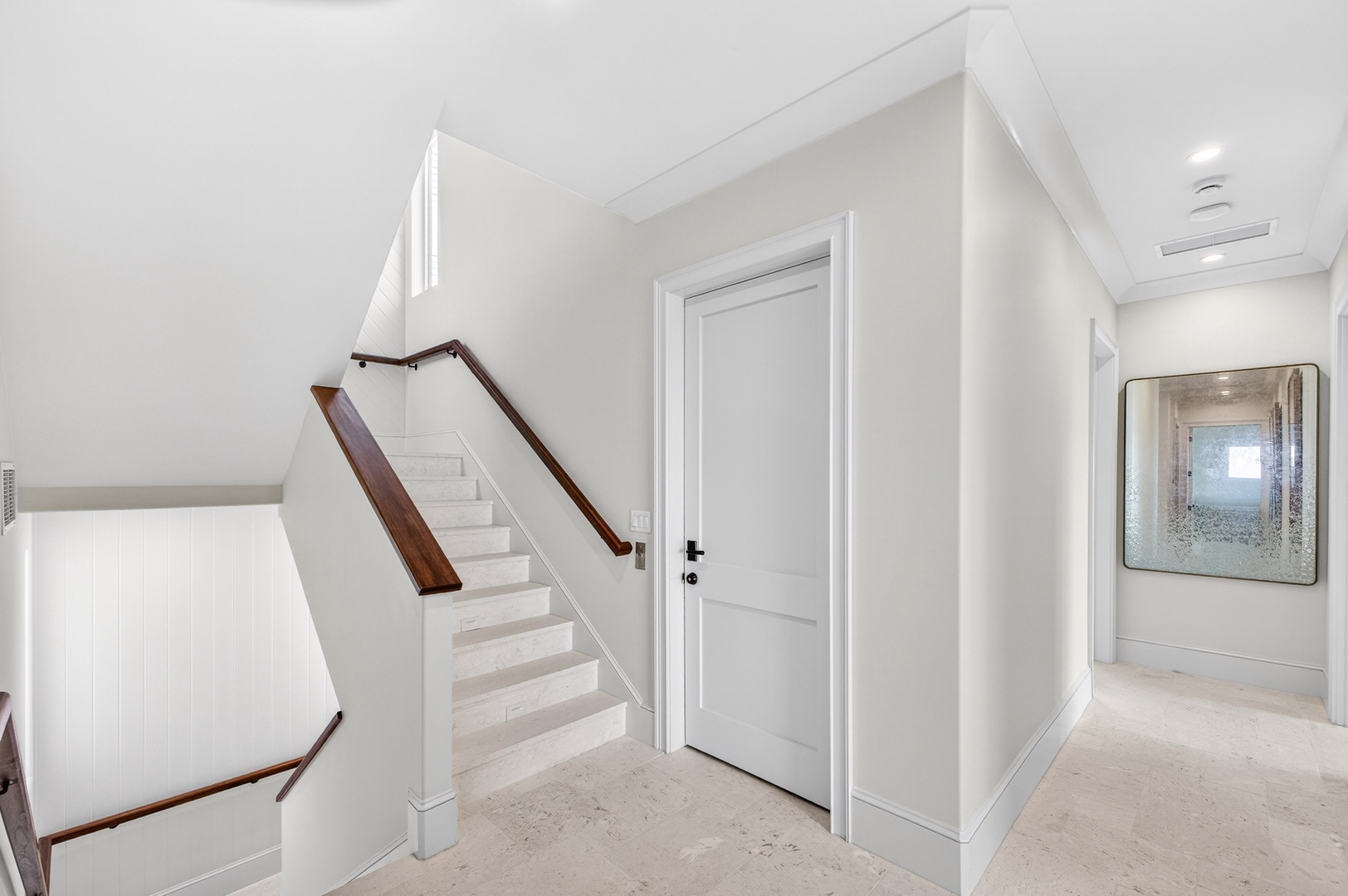 Step into this elegant hallway where clean lines and warm wood accents create a welcoming first impression for your stay.