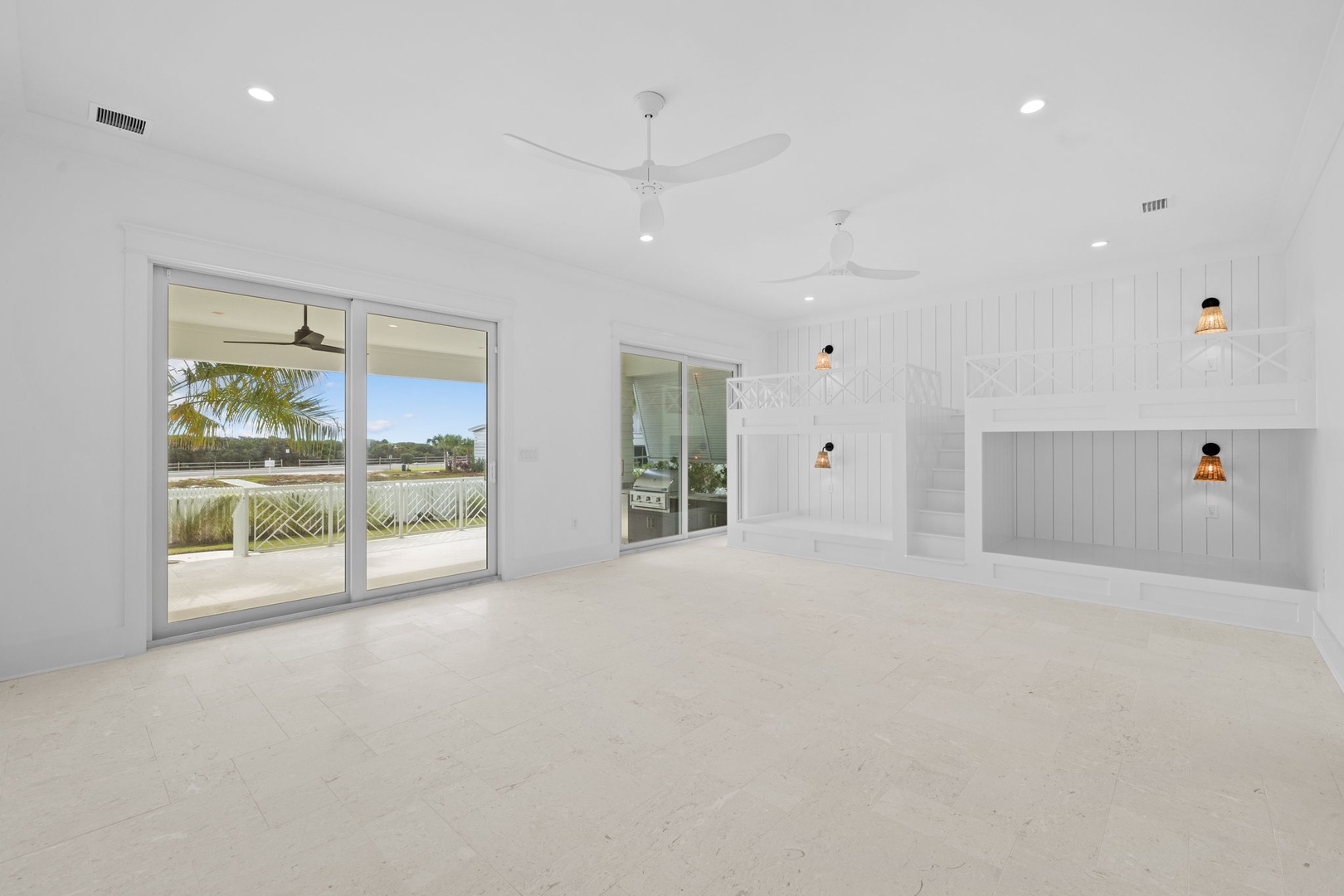 Your spacious living area flows seamlessly to an outdoor deck, where warm pendant lighting creates a welcoming atmosphere for relaxation.