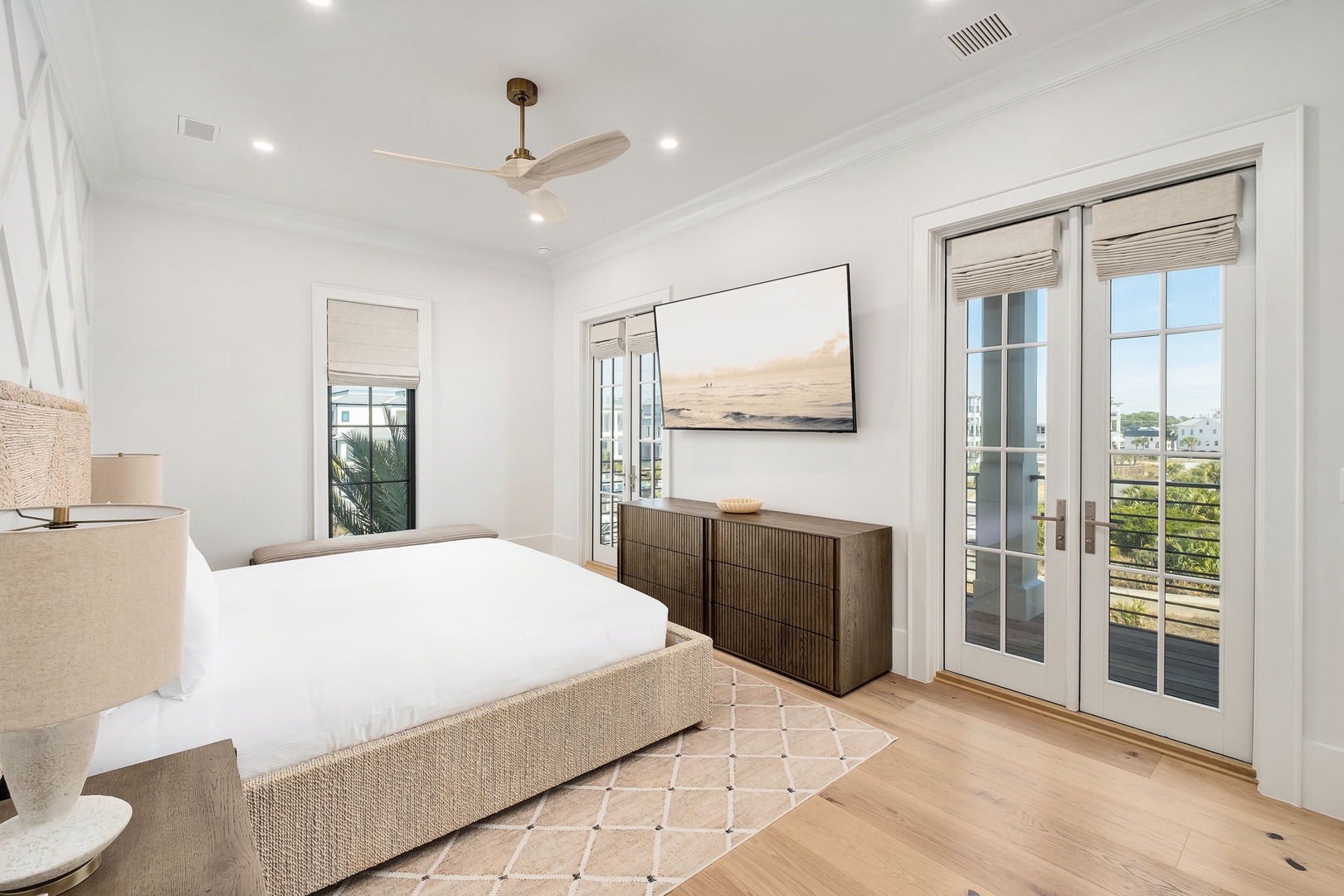 Wake up in your serene bedroom sanctuary, where crisp white linens and warm wood floors create the perfect retreat for restful nights.