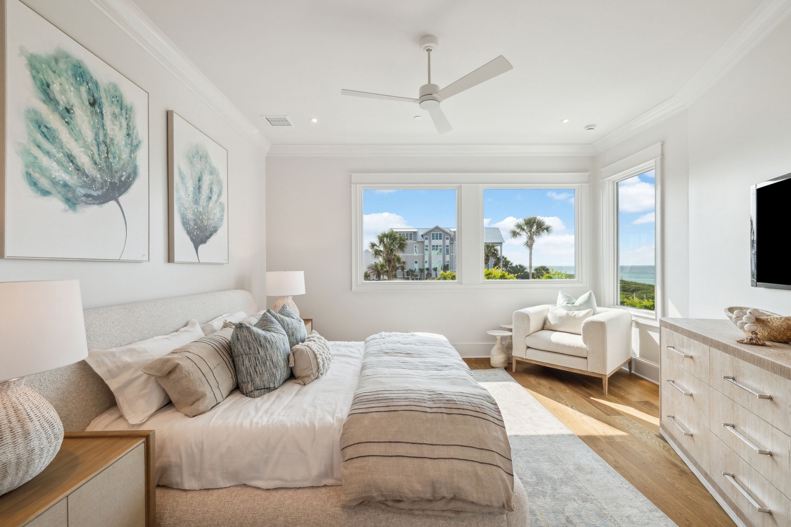 Wake up to coastal breezes and stunning water views from your serene bedroom retreat, where soft linens and calming coastal décor set the tone for pure relaxation.