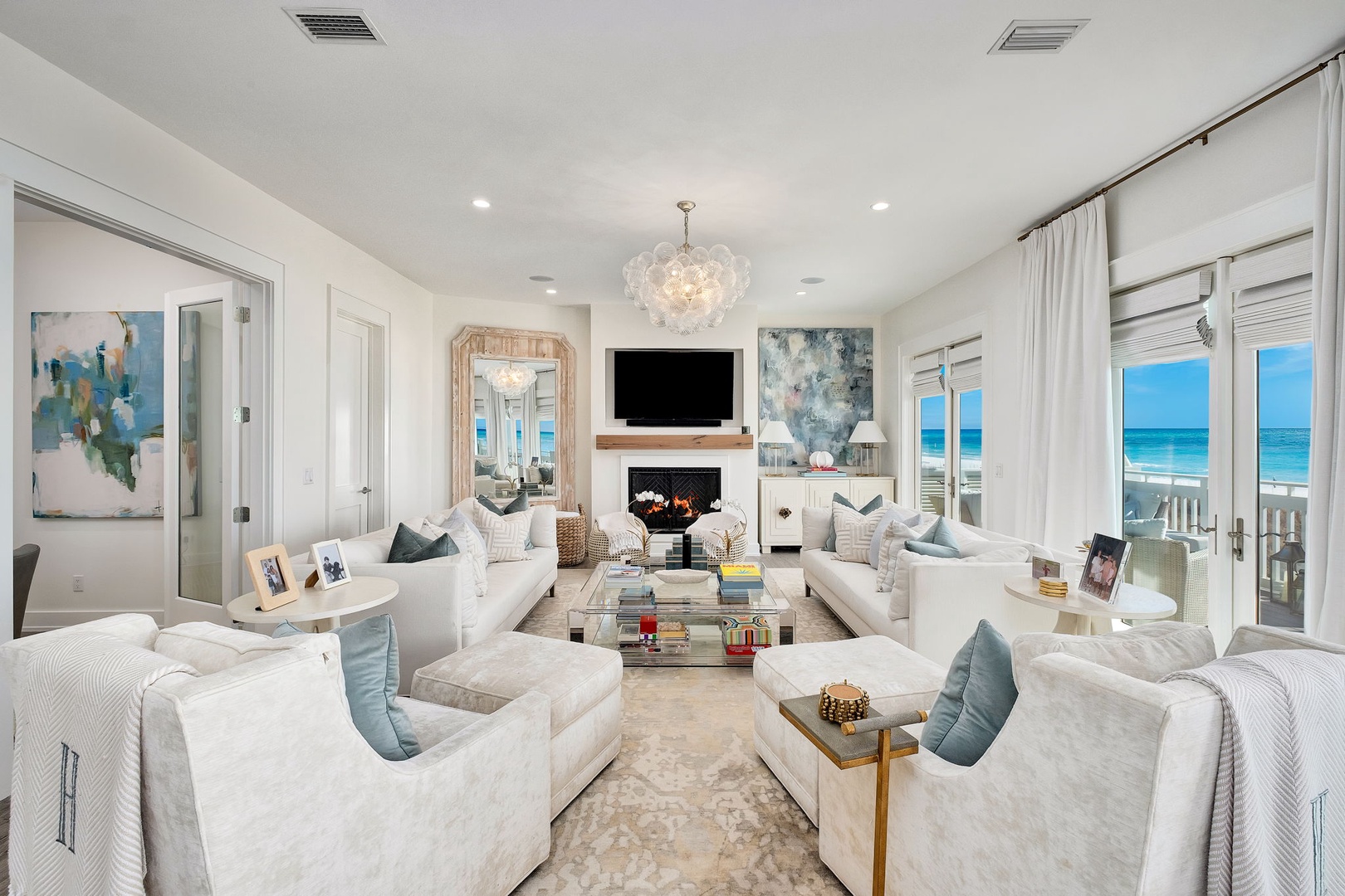 Sink into plush sofas and take in stunning ocean views through floor-to-ceiling windows, your perfect coastal retreat for relaxing evenings by the fireplace.