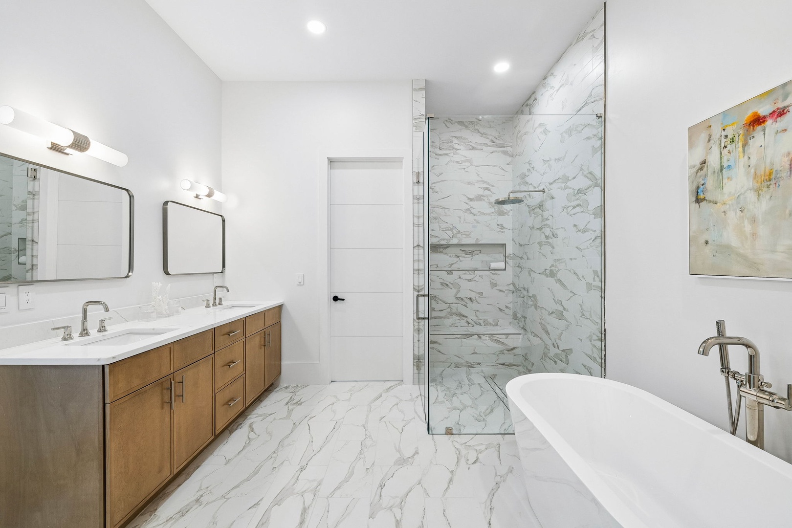 Step into your private spa-like retreat with elegant marble throughout, a luxurious soaking tub, and a spacious walk-in shower with rainfall head—your perfect escape after a day of adventure.