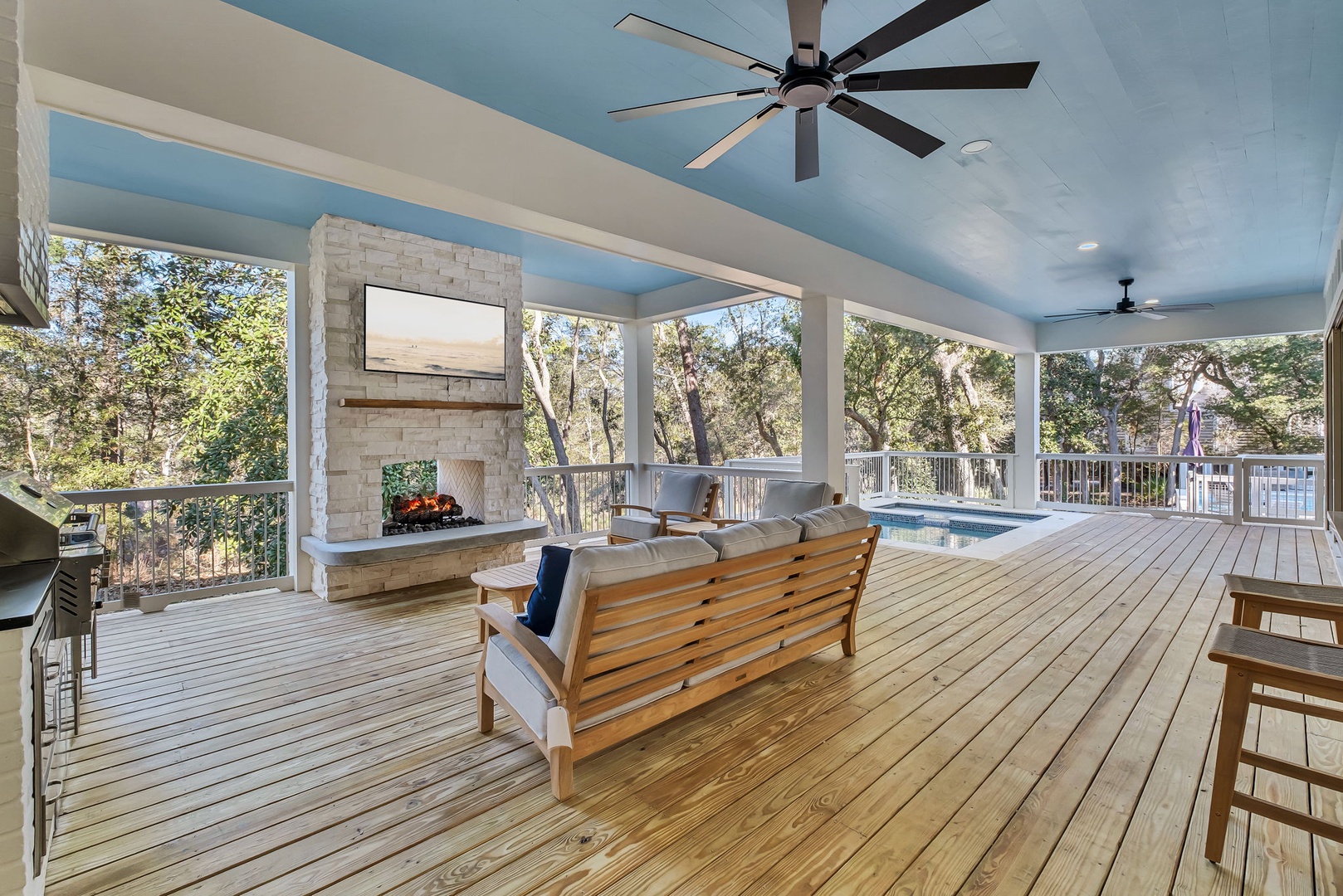 Unwind on your private covered deck with pool views, cozy fireplace, and ceiling fans for perfect comfort.