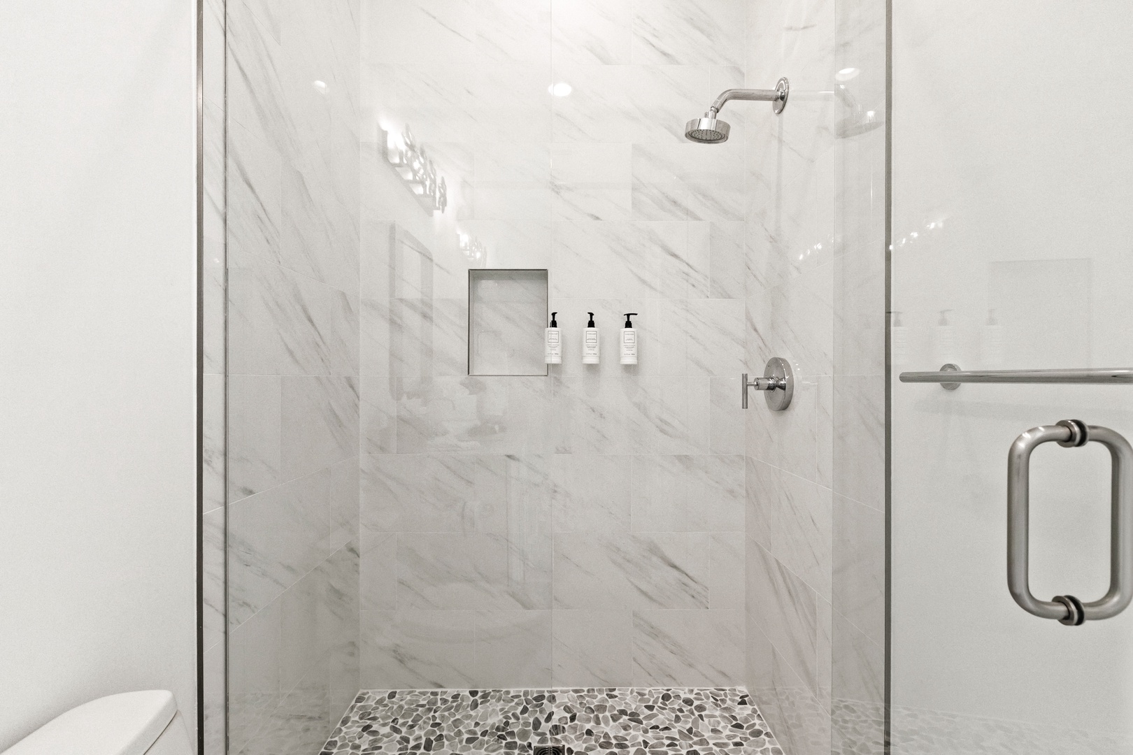 Step into your elegant marble shower, where modern design meets comfort. A built-in niche holds your toiletries, while the rainfall showerhead promises a refreshing escape after each adventure-filled day.