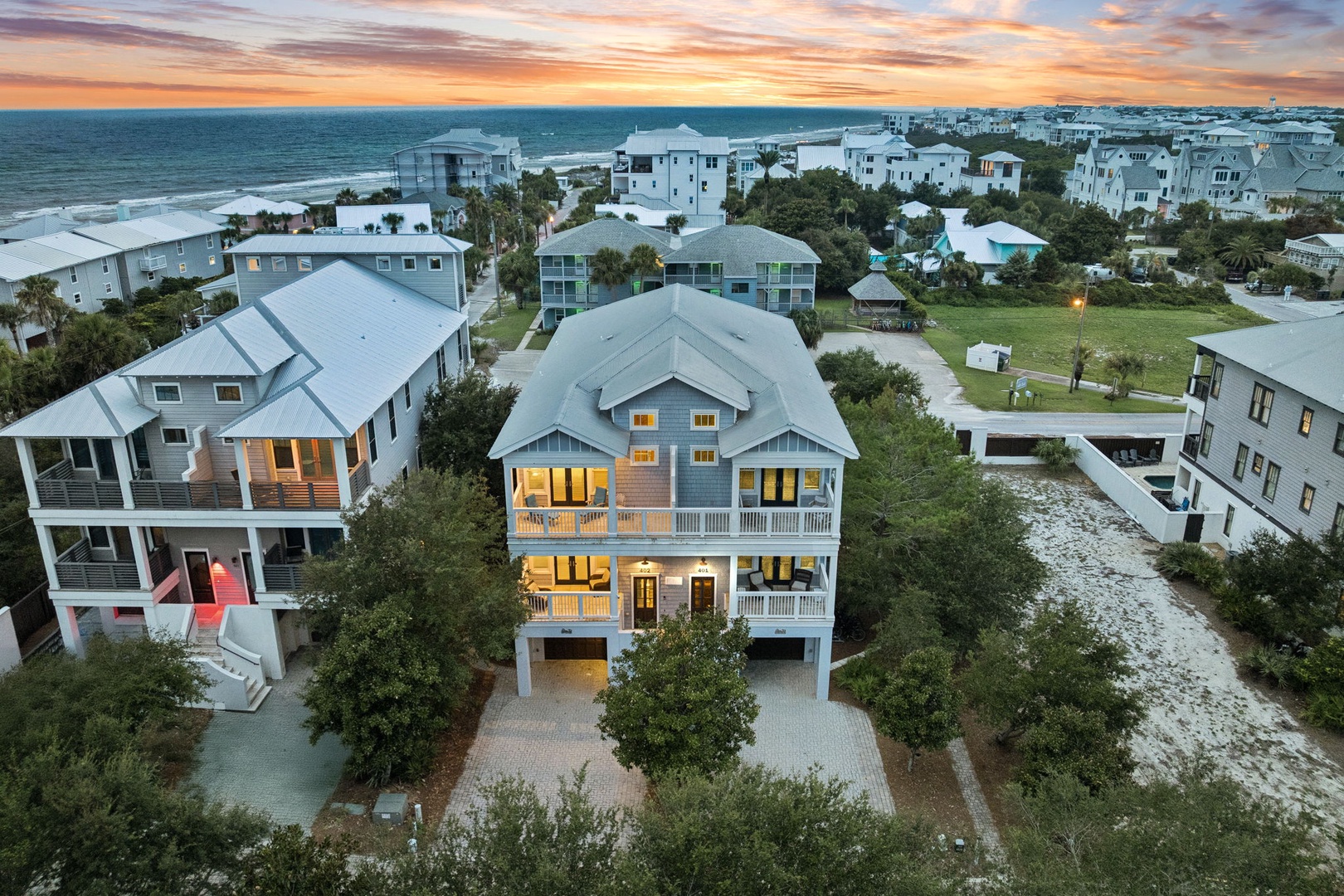 Stunning coastal property just a short stroll from the beach, surrounded by lush greenery and neighboring homes, perfectly positioned to enjoy the serene seaside community.