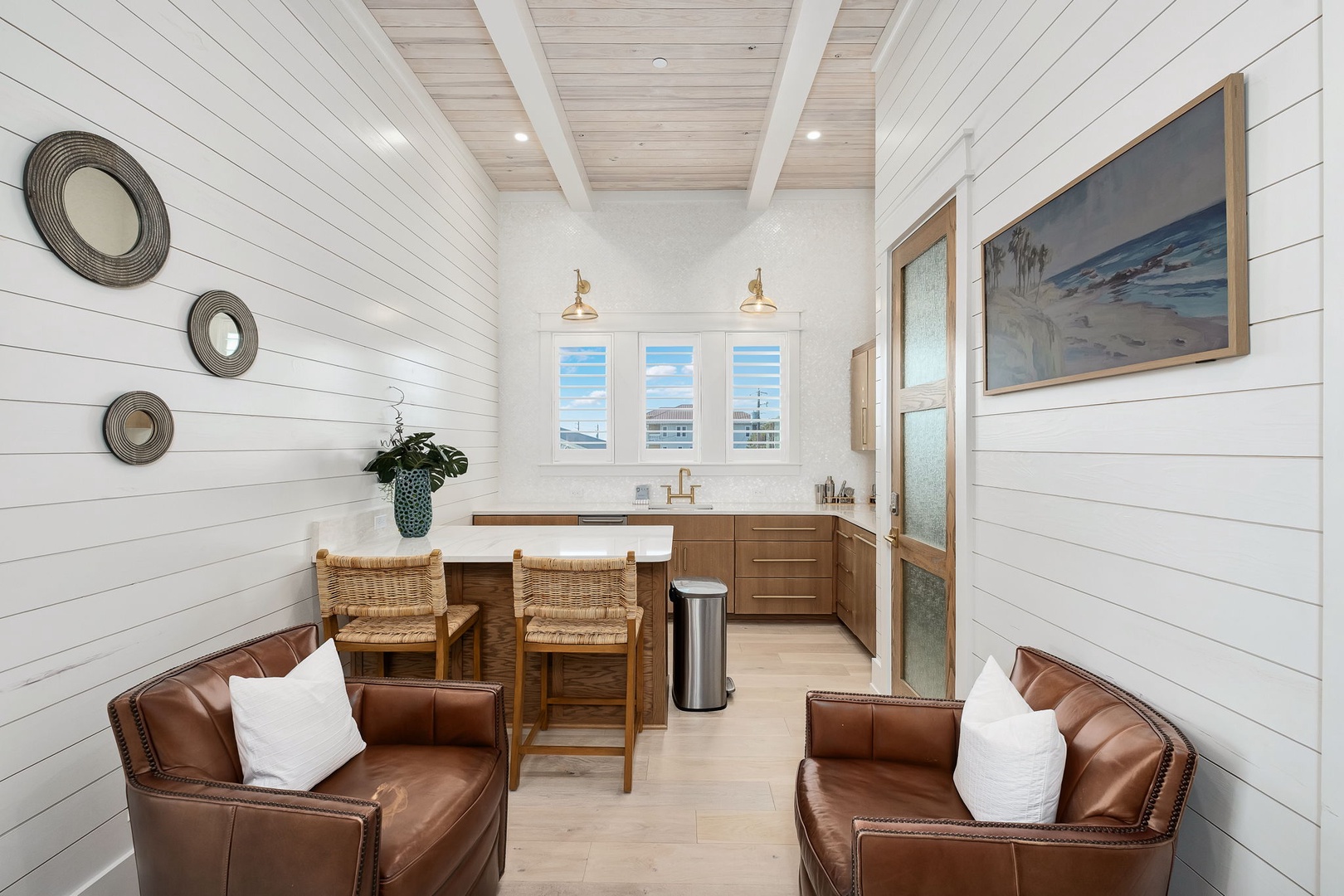Relax in your coastal retreat with warm leather seating and kitchen island perfect for morning coffee while ocean breezes flow through.