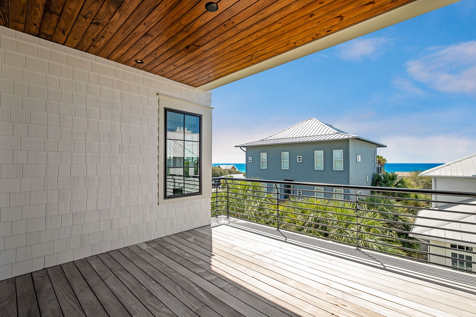 Step onto your private balcony and soak in stunning ocean glimpses framed by coastal charm and swaying palms.