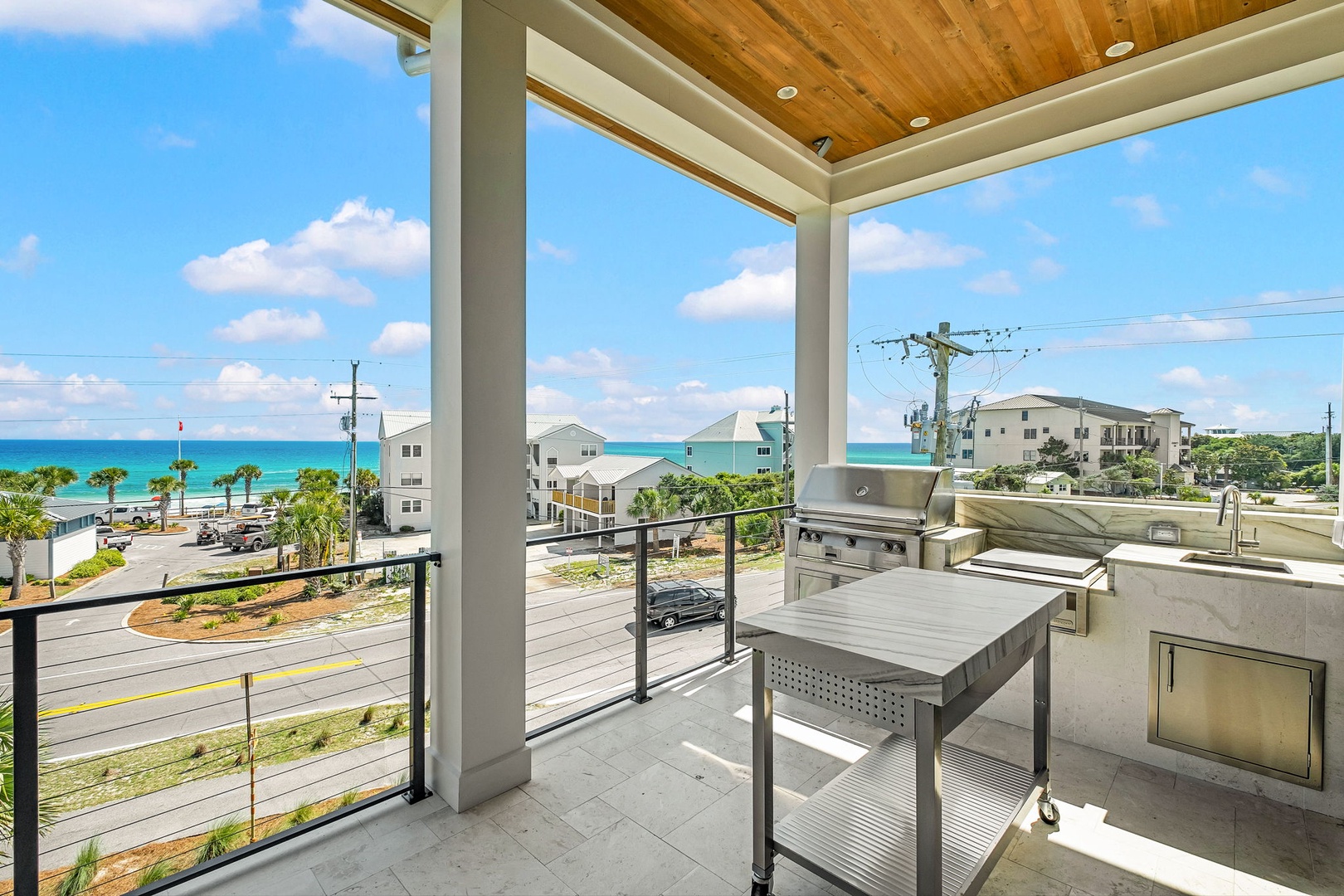Step onto your covered terrace and take in stunning turquoise ocean views while grilling your catch of the day. The outdoor kitchen makes beachside living effortless and unforgettable.
