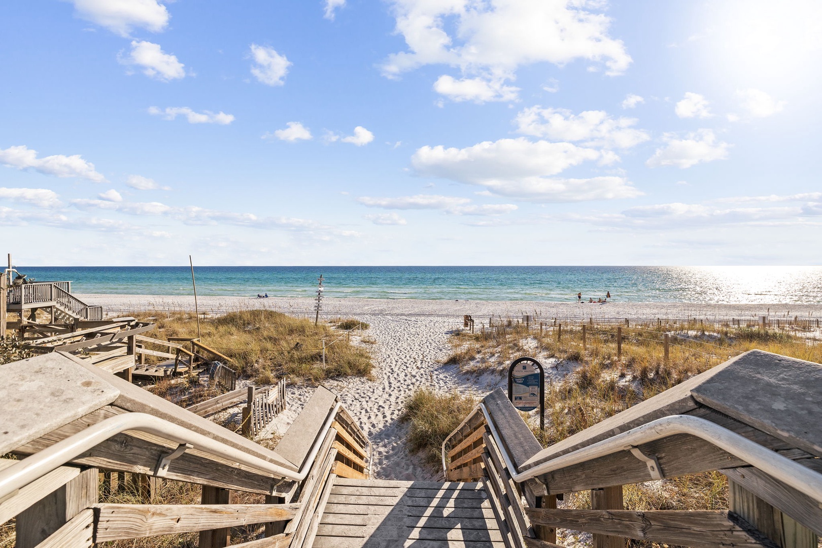 Coastal paradise awaits beyond the boardwalk, where pristine beaches meet turquoise waters.