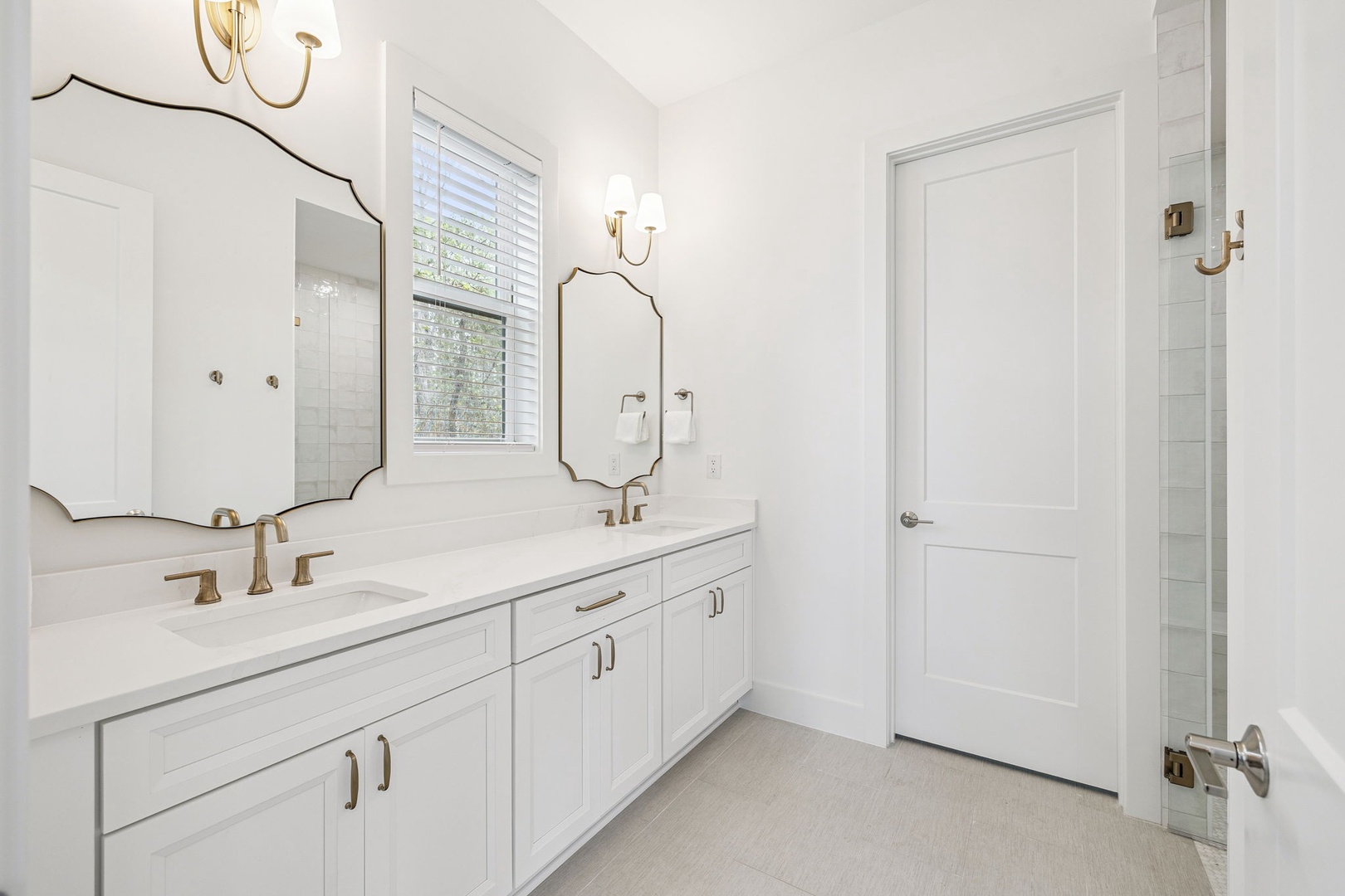 Your elegant master bathroom features dual vanities with marble countertops, perfect for your morning routine in sophisticated style.