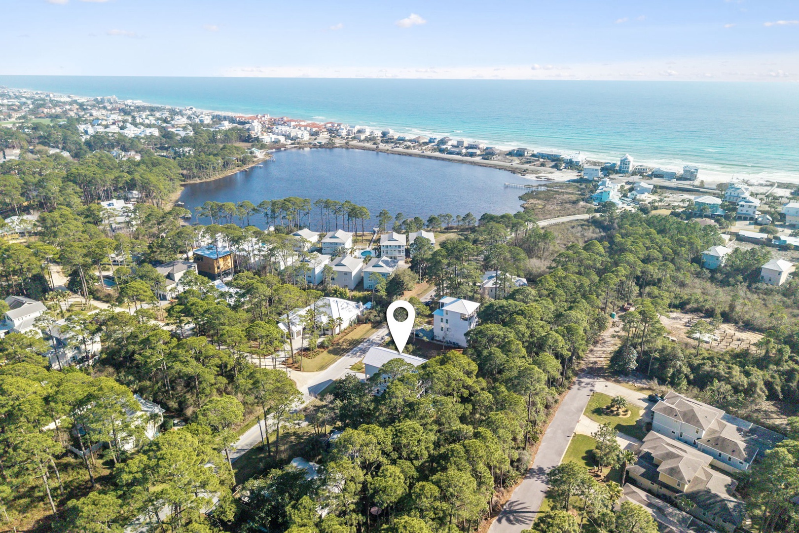 Coastal community with pristine beaches, tranquil lake, and lush forest surroundings offering peaceful retreat near the Gulf waters.