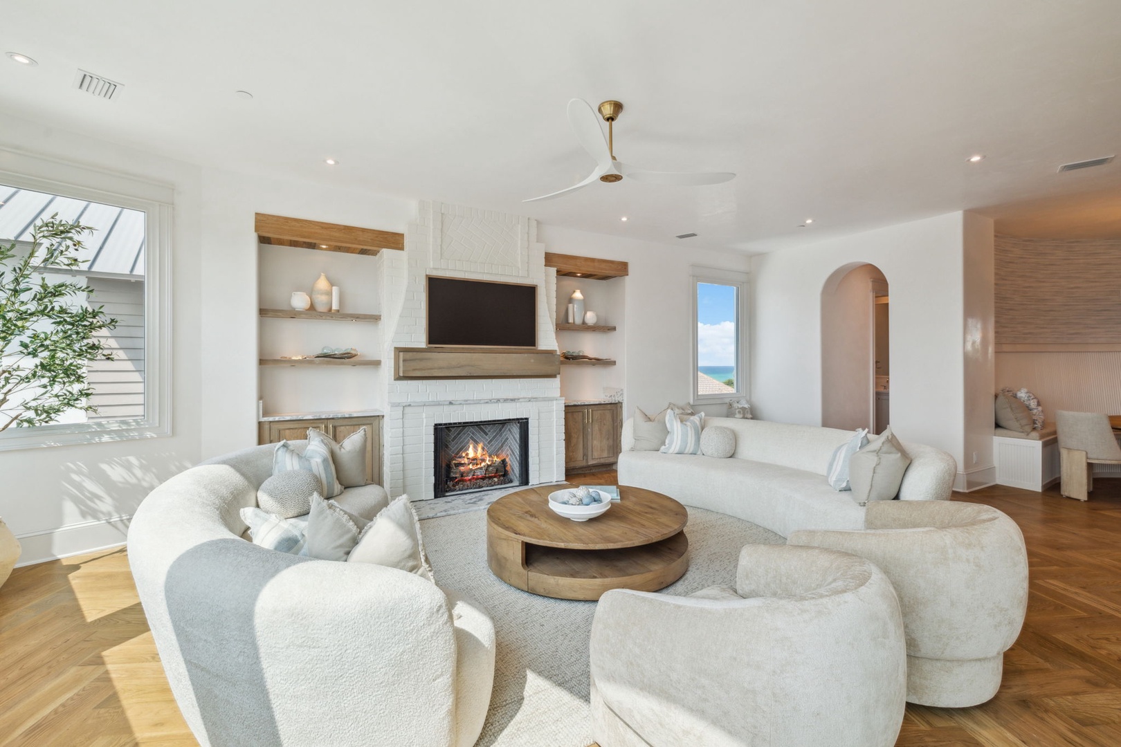 Sink into plush seating around the fireplace and ocean views, your peaceful coastal haven awaits.
