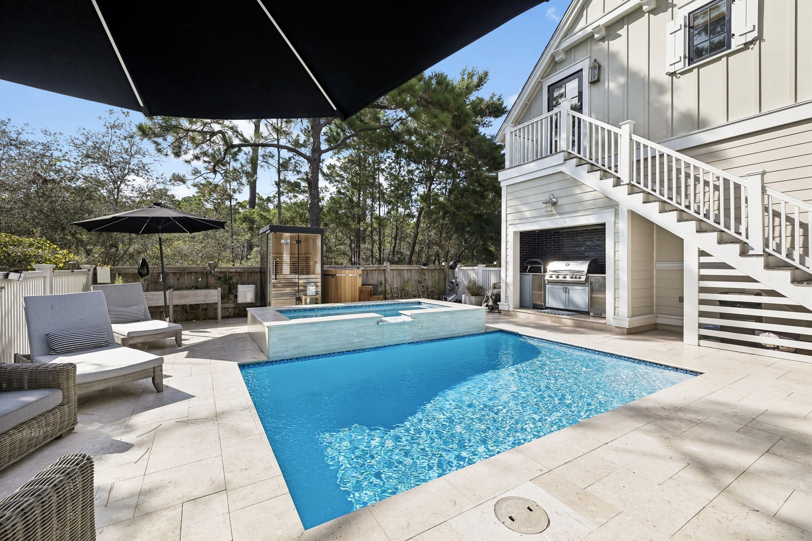Your private paradise awaits with a sparkling pool, hot tub, sauna, and built-in BBQ grill—perfect for relaxing afternoons or hosting memorable evenings under the sun or stars.