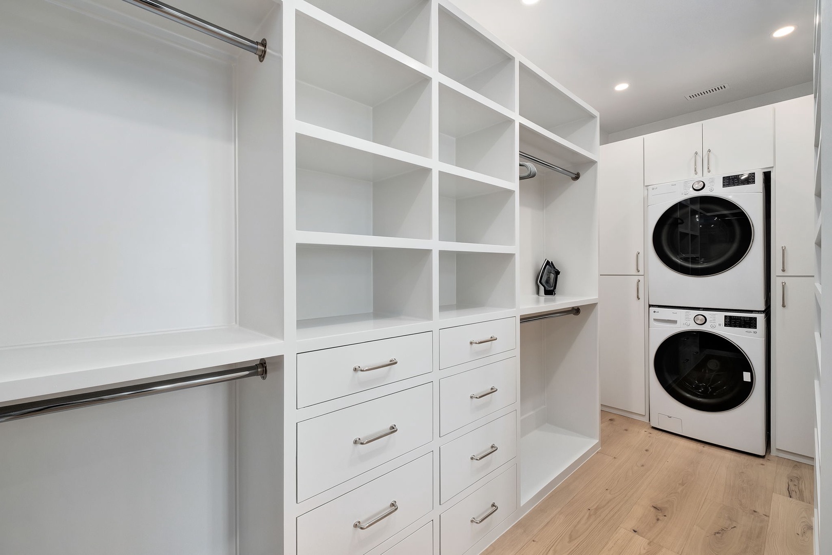 Your spacious walk-in closet features custom built-in shelving, drawers, and hanging space, plus convenient in-unit washer and dryer.