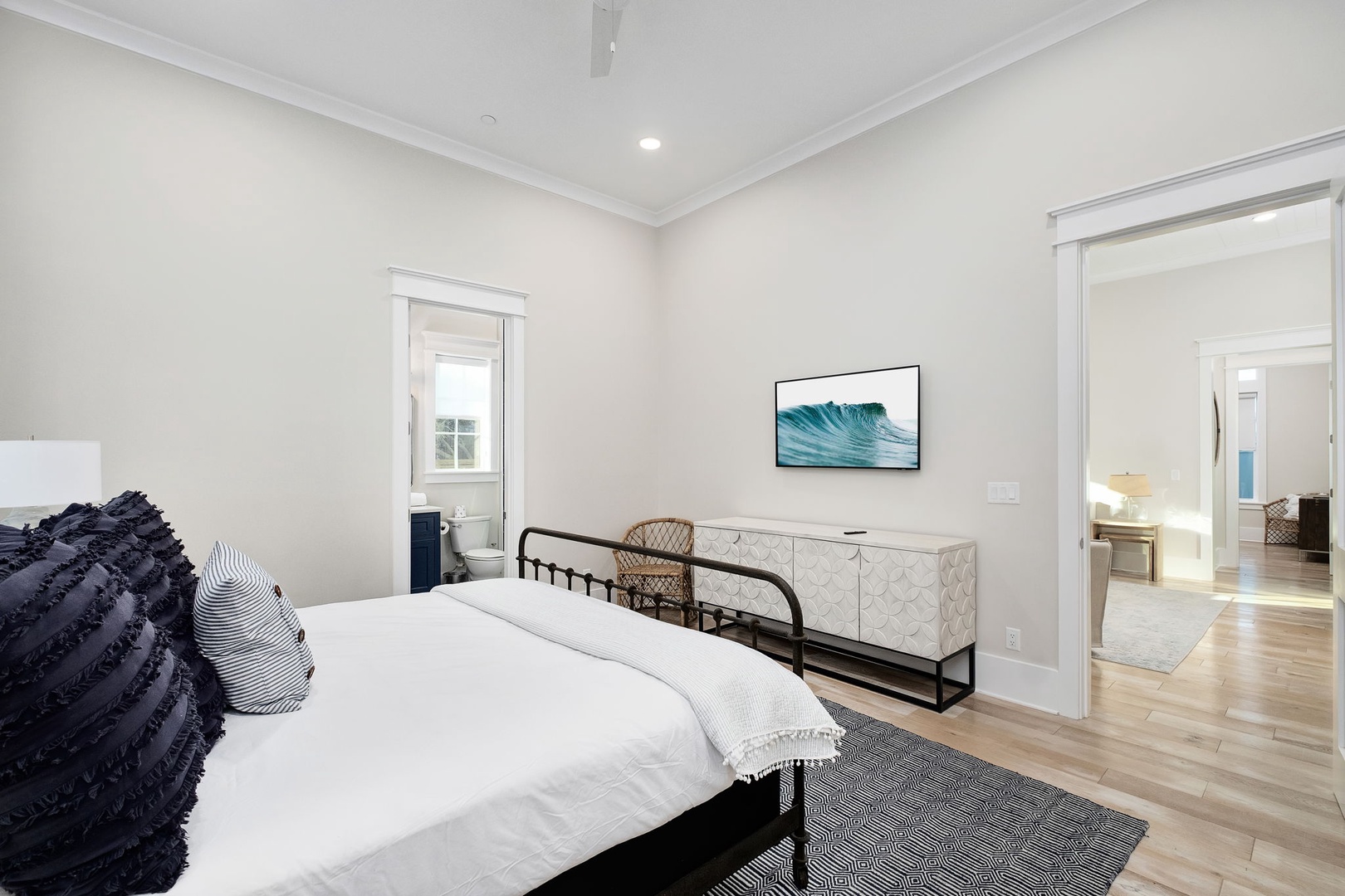 Wake up in your serene master bedroom featuring coastal art, stylish furnishings, and an ensuite bathroom for ultimate comfort.