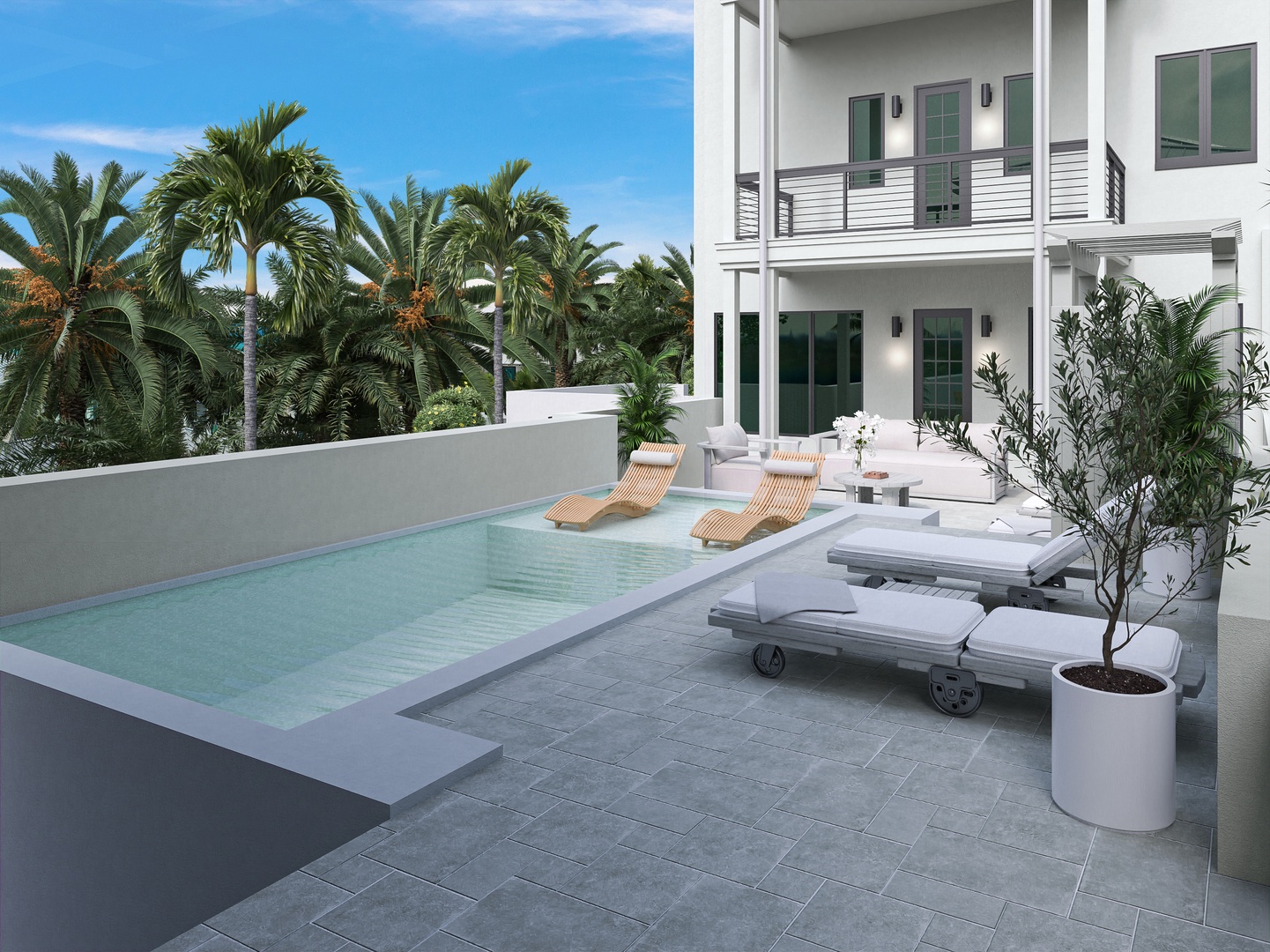 Your private pool courtyard features modern lounge chairs and tropical palm surroundings, creating a serene spot to soak up the sun and unwind.
