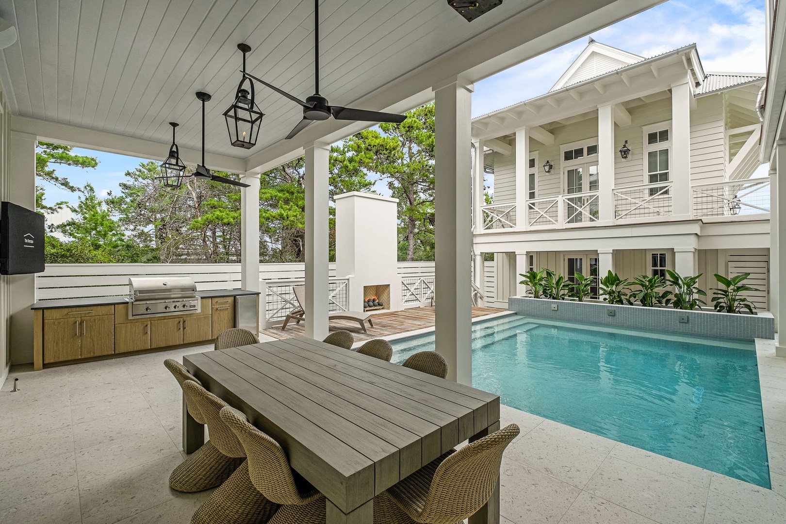 Private covered patio overlooking your pool and outdoor kitchen—perfect for alfresco dining and entertaining under the palms.