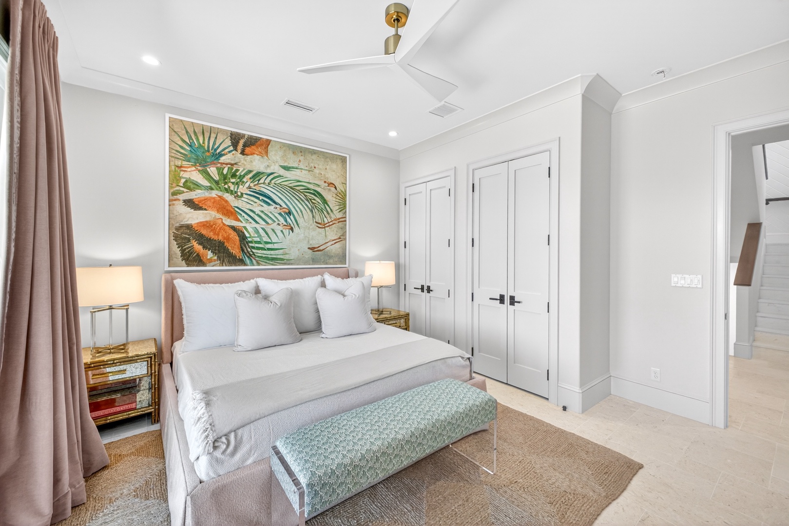 Sink into crisp linens and tropical vibes in your private retreat, where soft textures and coastal art create a serene escape for restful nights.