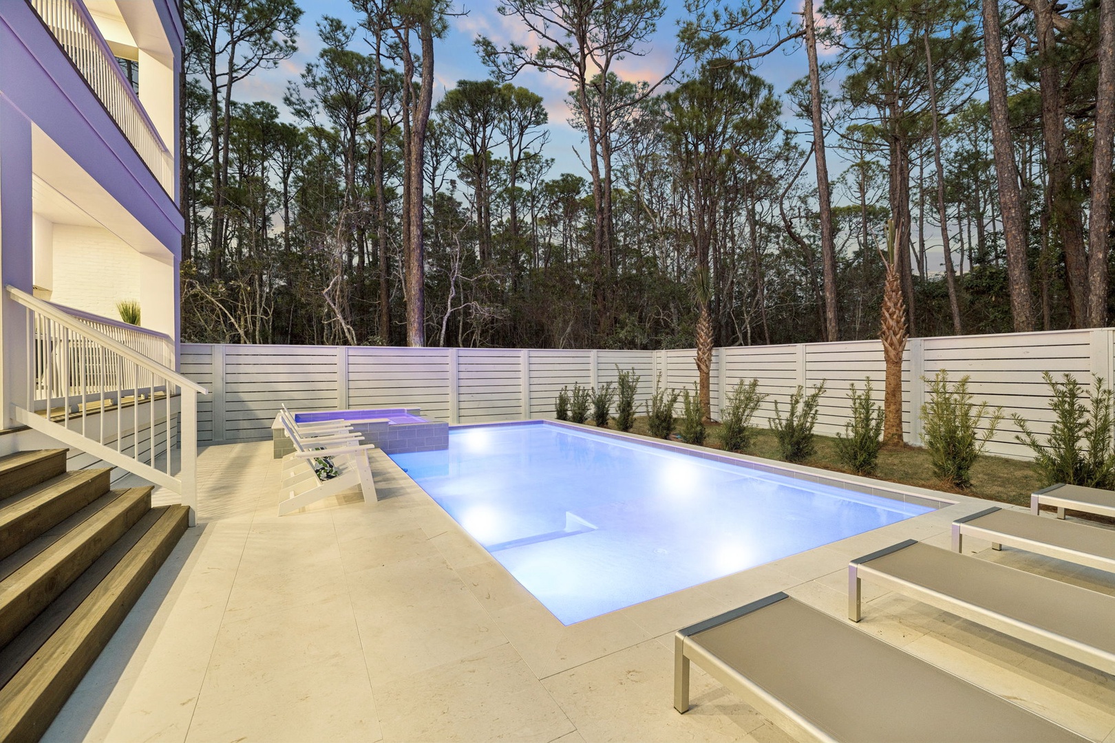 Your private oasis awaits with a sparkling pool surrounded by natural forest views and elegant outdoor lounging space.