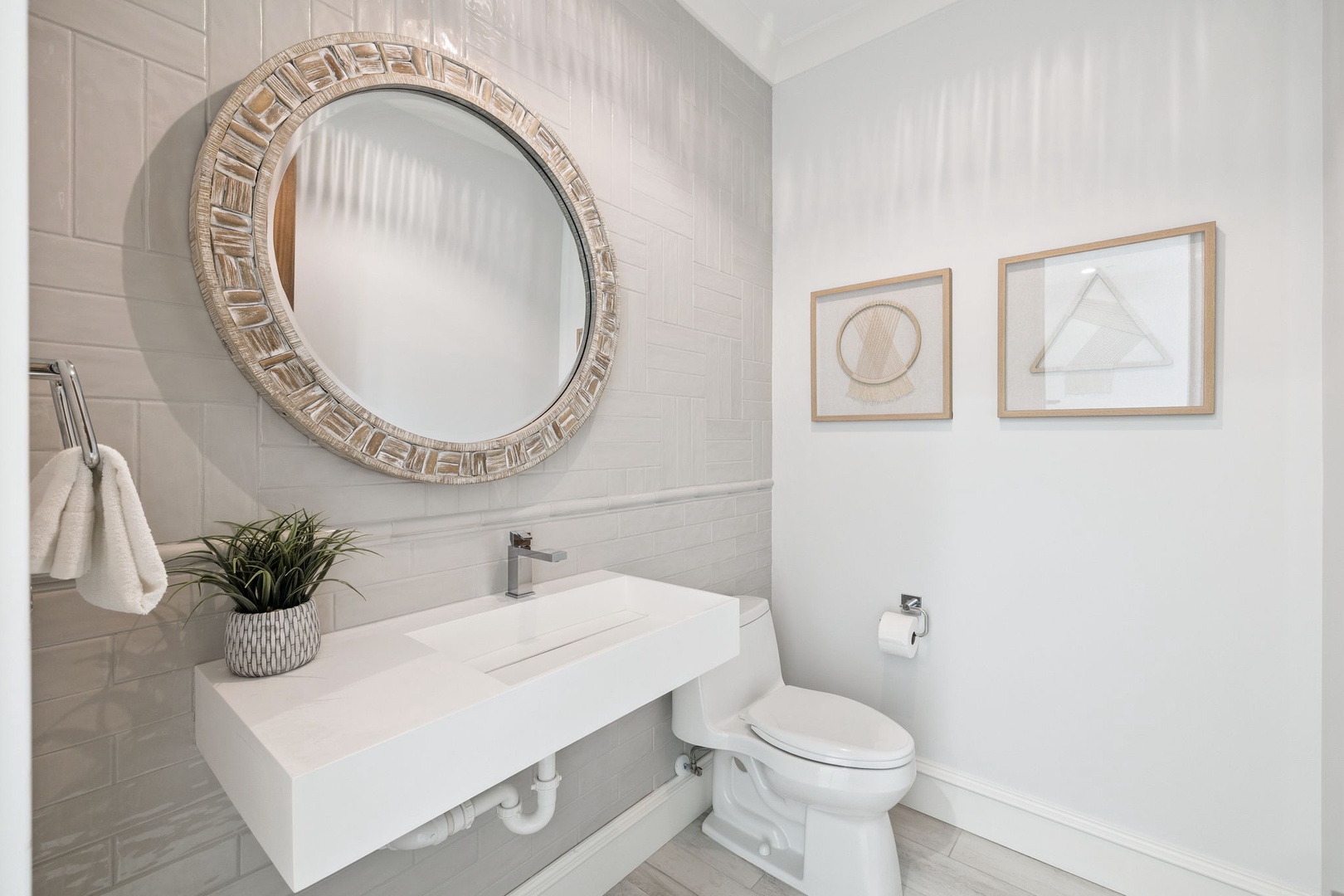 Step into your elegant powder room featuring a stunning round mirror and modern floating vanity for a refreshing start to your day.