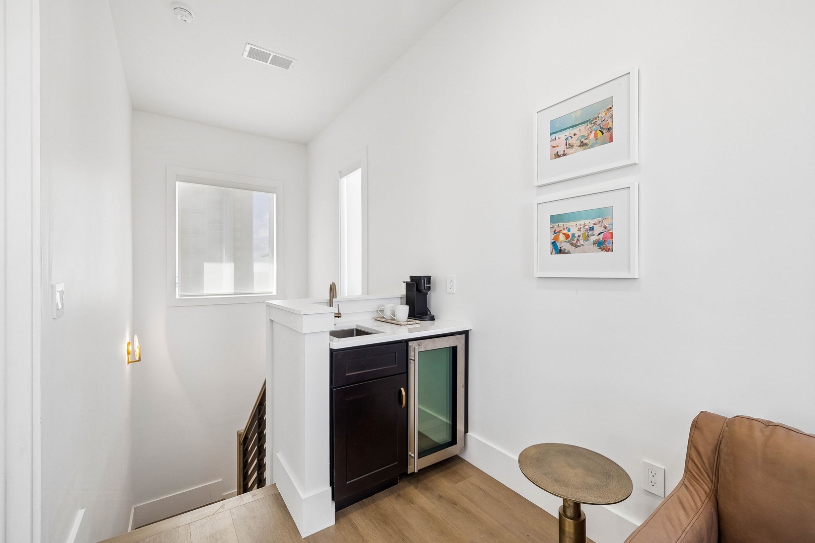 A cozy beverage station awaits with a sleek mini-fridge and coffee maker, perfect for your morning routine or evening refreshments.