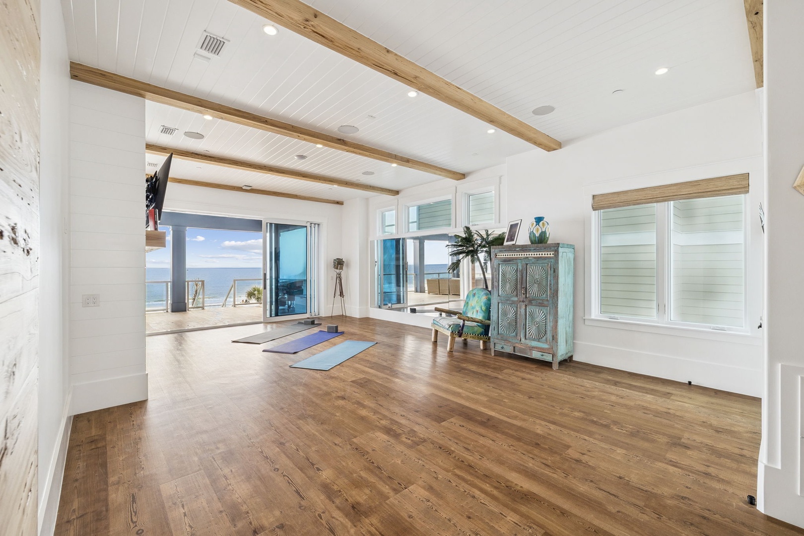 Unroll your yoga mat in this serene beachfront studio where ocean breezes flow through open doors and exposed beams frame your peaceful practice.