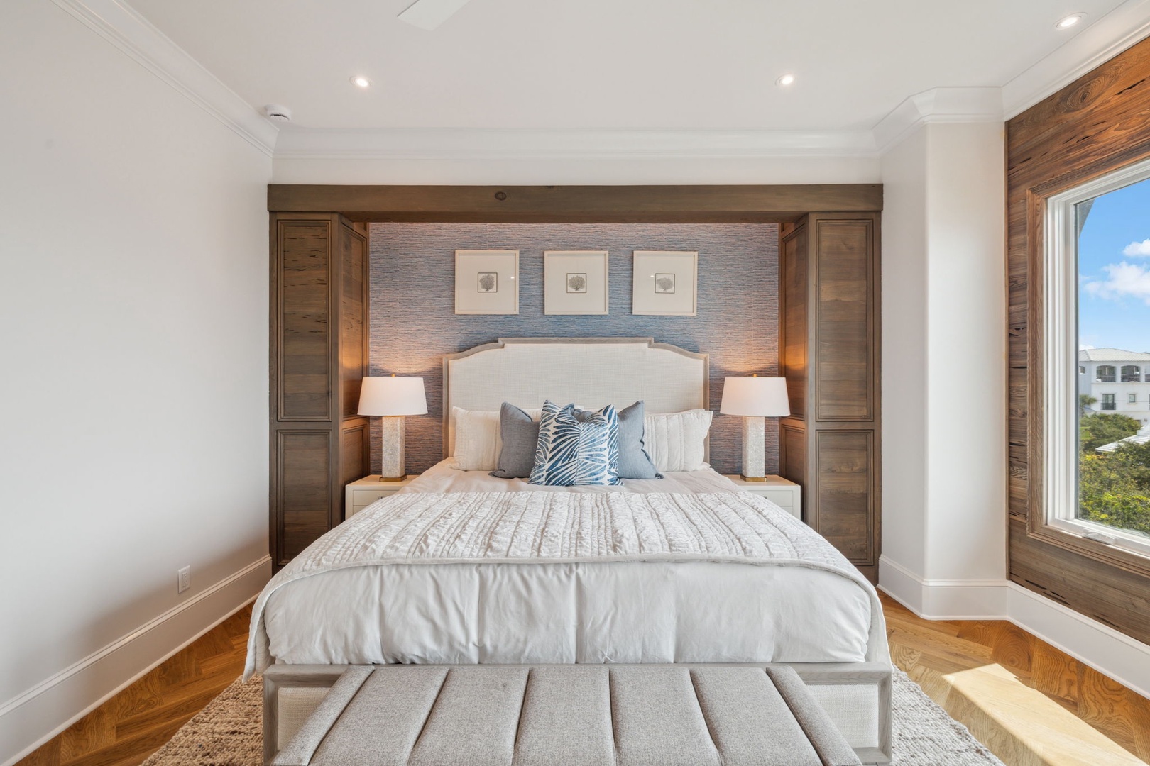 Sink into plush bedding beneath warm wood accents and soft lighting. Your serene retreat features built-in storage and elegant design details for a truly restful escape.