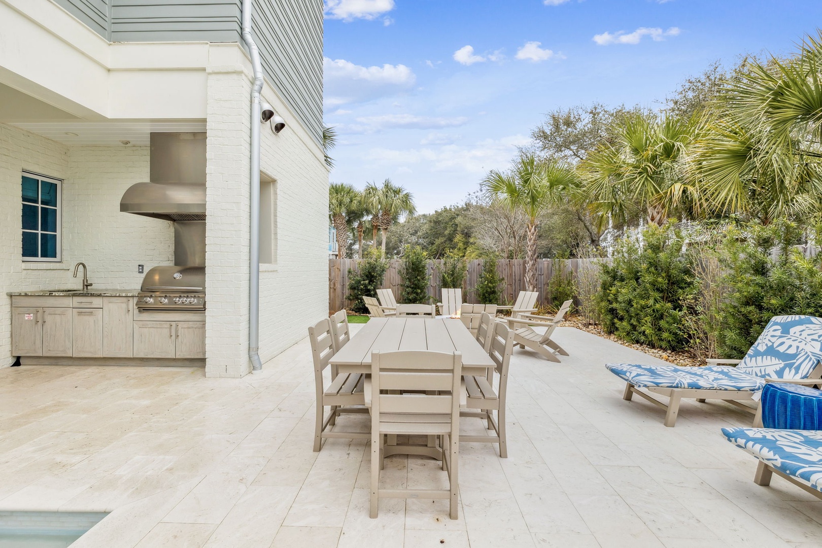 Relax on your private poolside terrace with outdoor dining, BBQ station, and comfortable loungers surrounded by tropical palms.