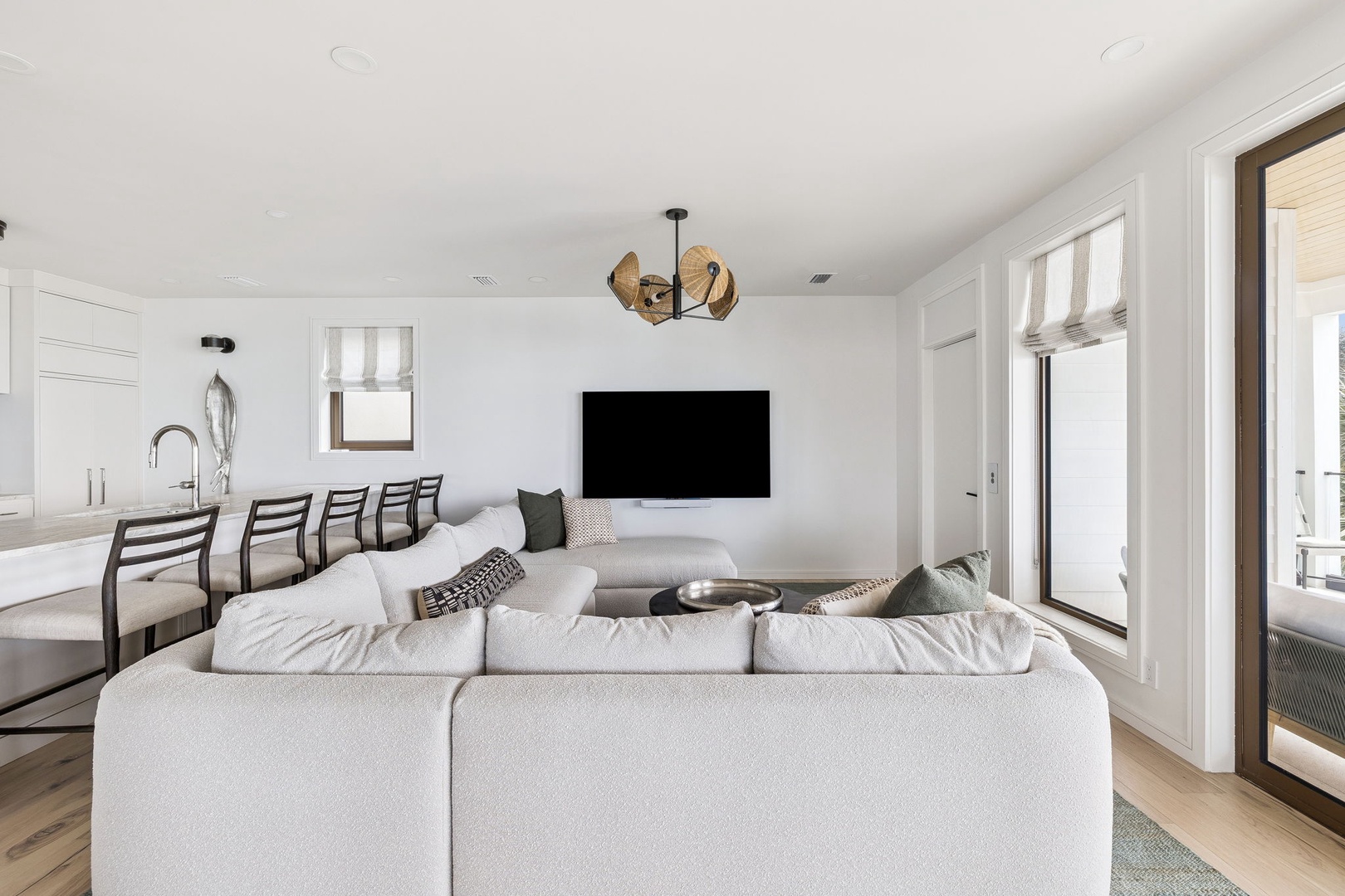 Sink into the plush sectional sofa and enjoy your favorite shows on the wall-mounted TV in this bright, modern living space.