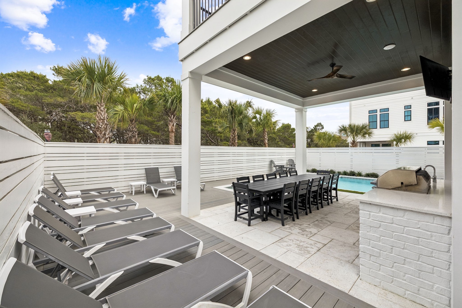 Unwind on comfortable lounge chairs while your group gathers around the spacious dining table, all under the covered pavilion.