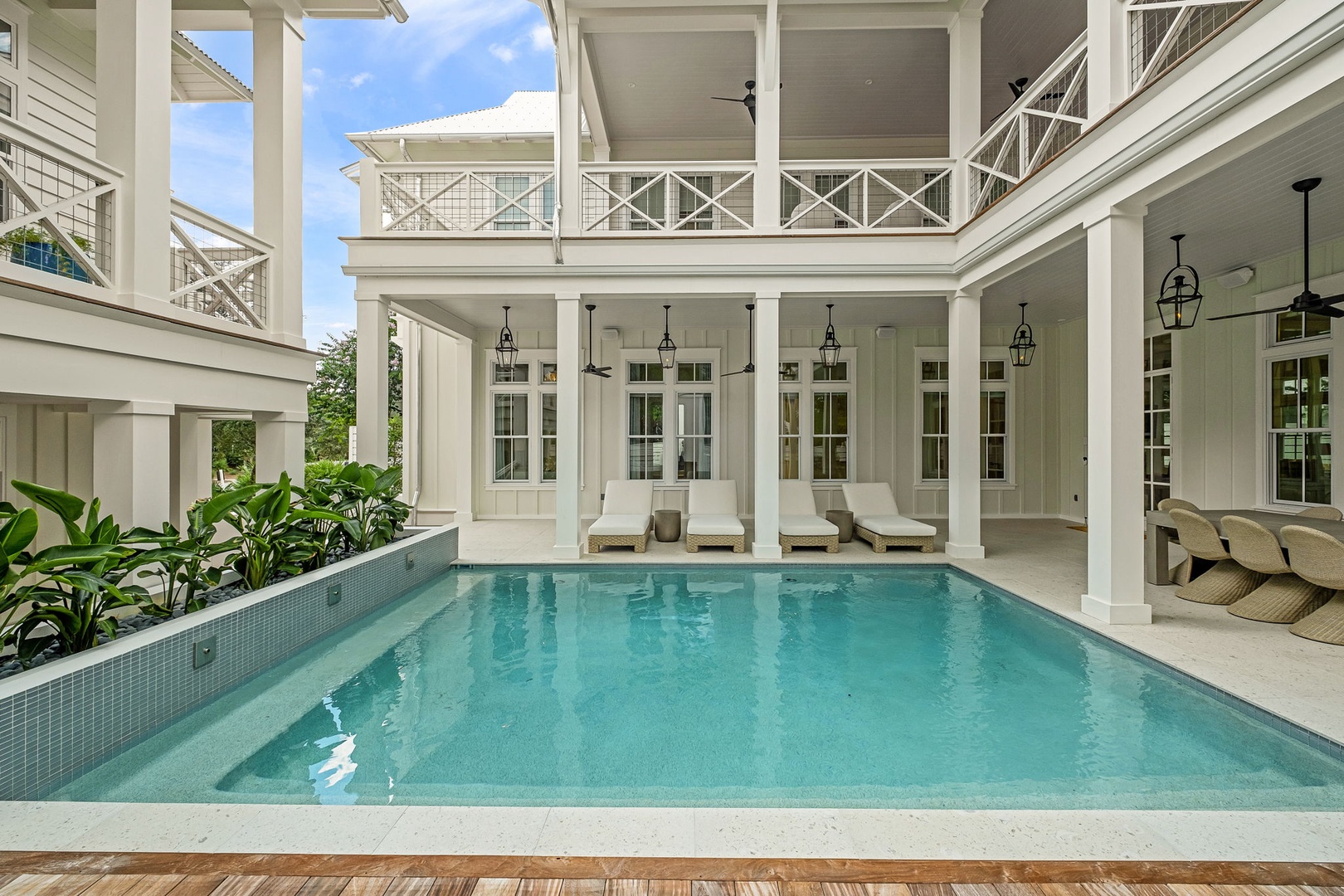 Your private courtyard oasis awaits—dive into crystal-clear waters framed by elegant columns and lush greenery, with cozy loungers ready for sun-soaked relaxation.
