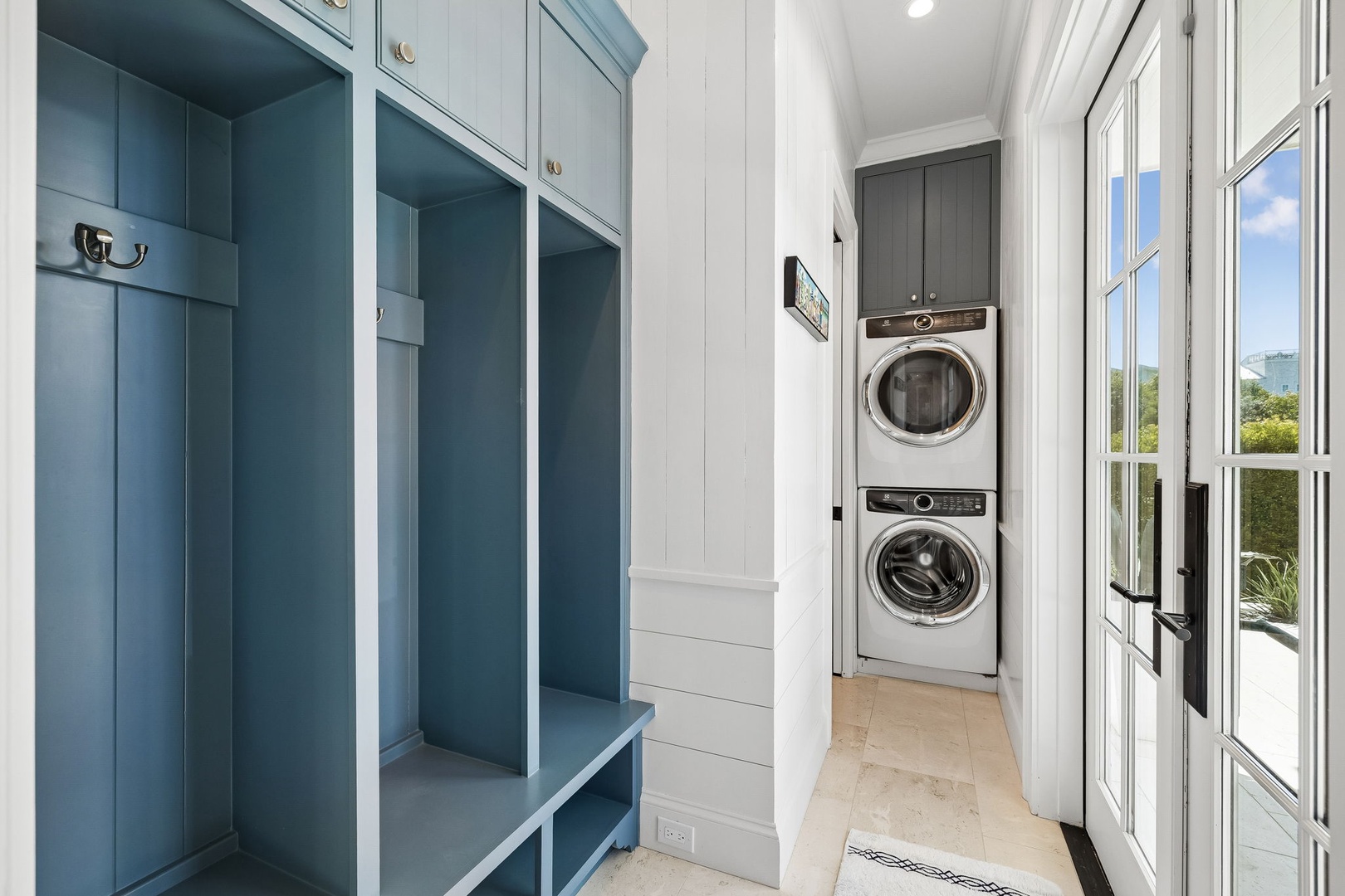 Tuck away your beach gear in charming cubbies, then toss your sandy towels into the stacked washer and dryer—effortless coastal living at your fingertips.
