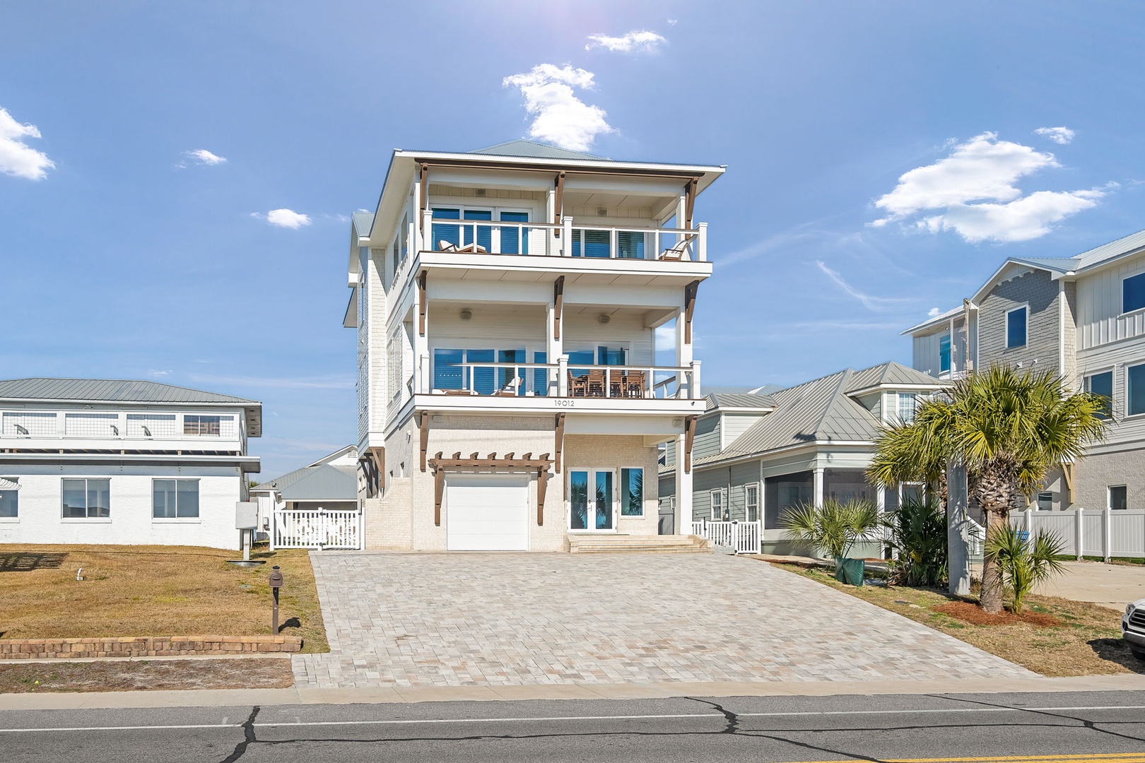 Modern three-story beach house with expansive balconies and coastal charm in a desirable neighborhood.