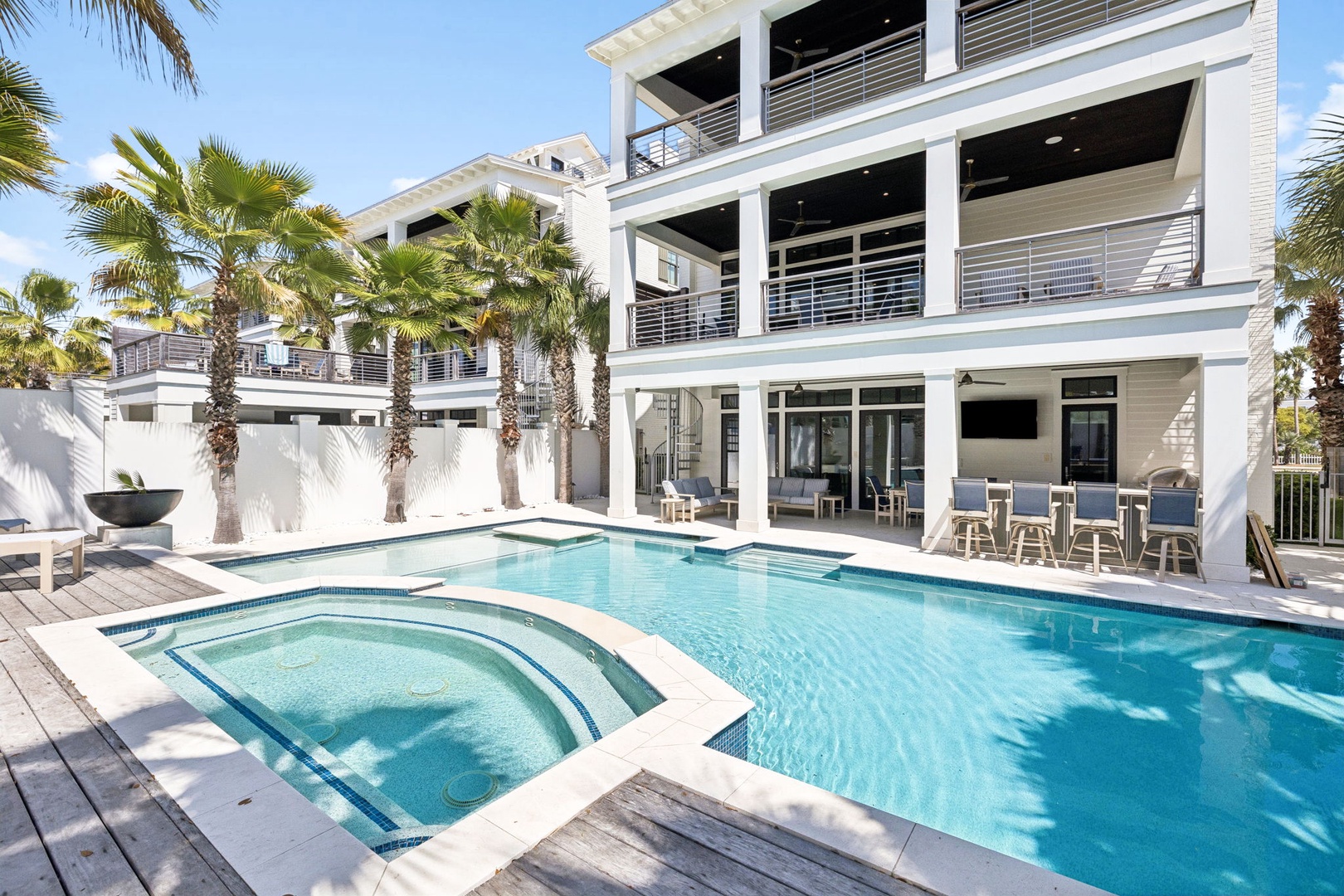 Stunning modern villa with private pool and hot tub surrounded by swaying palms—your perfect tropical escape awaits.