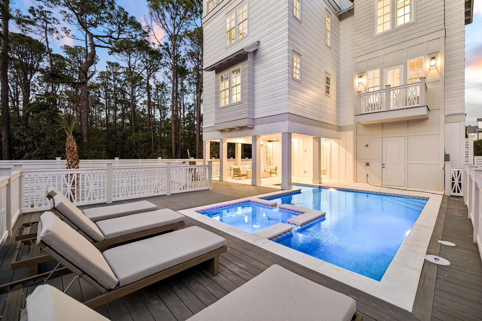 Unwind beside your private pool and hot tub as evening lights create a magical ambiance on your spacious deck.
