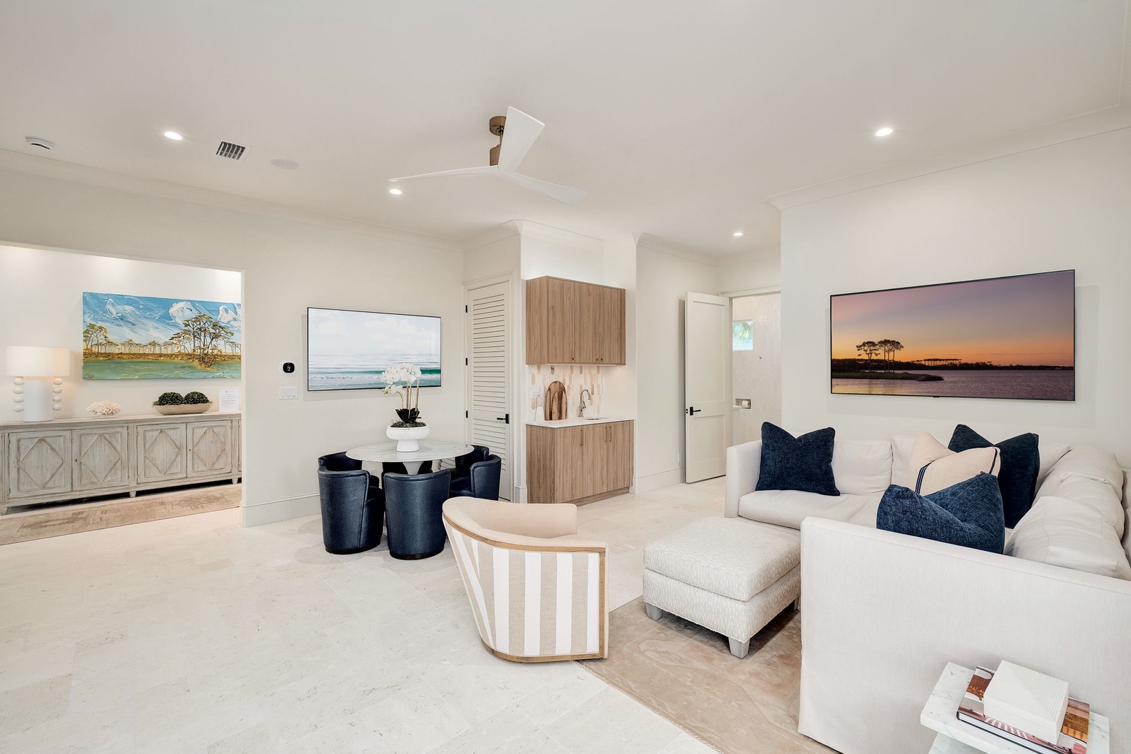 Sink into plush seating and unwind in your bright, beautifully appointed living area, where coastal artwork and natural tones create a calming retreat after a day of adventure.