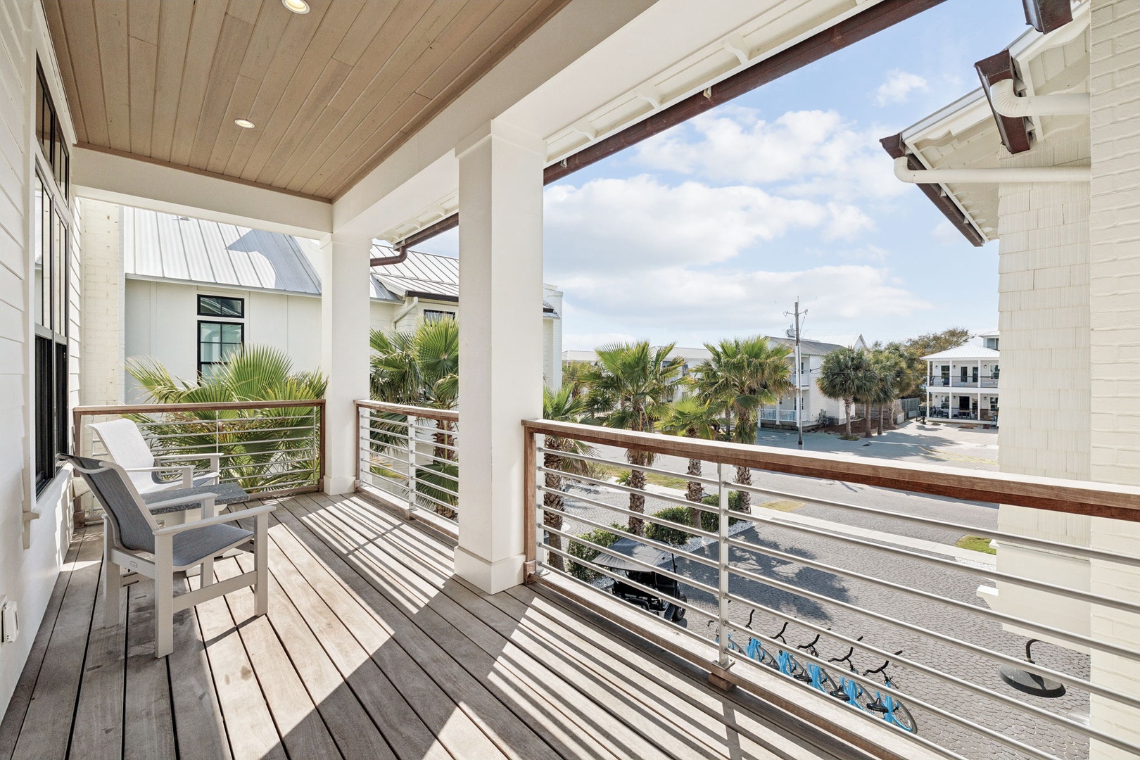 Relax on your private balcony with comfortable seating and enjoy peaceful street views framed by swaying palms.