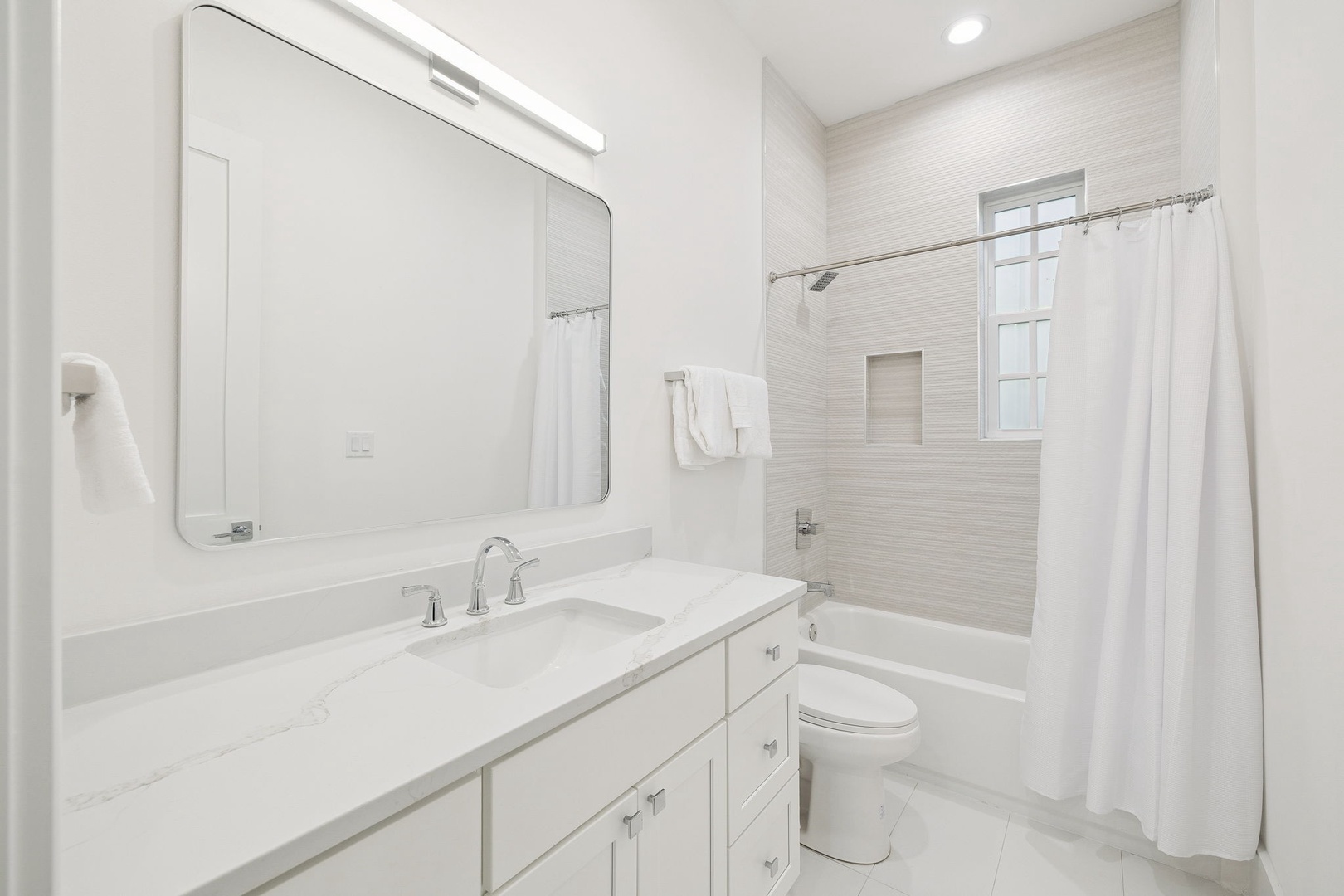 Your pristine bathroom features a spacious vanity and relaxing tub-shower combo, perfect for unwinding after your adventures.