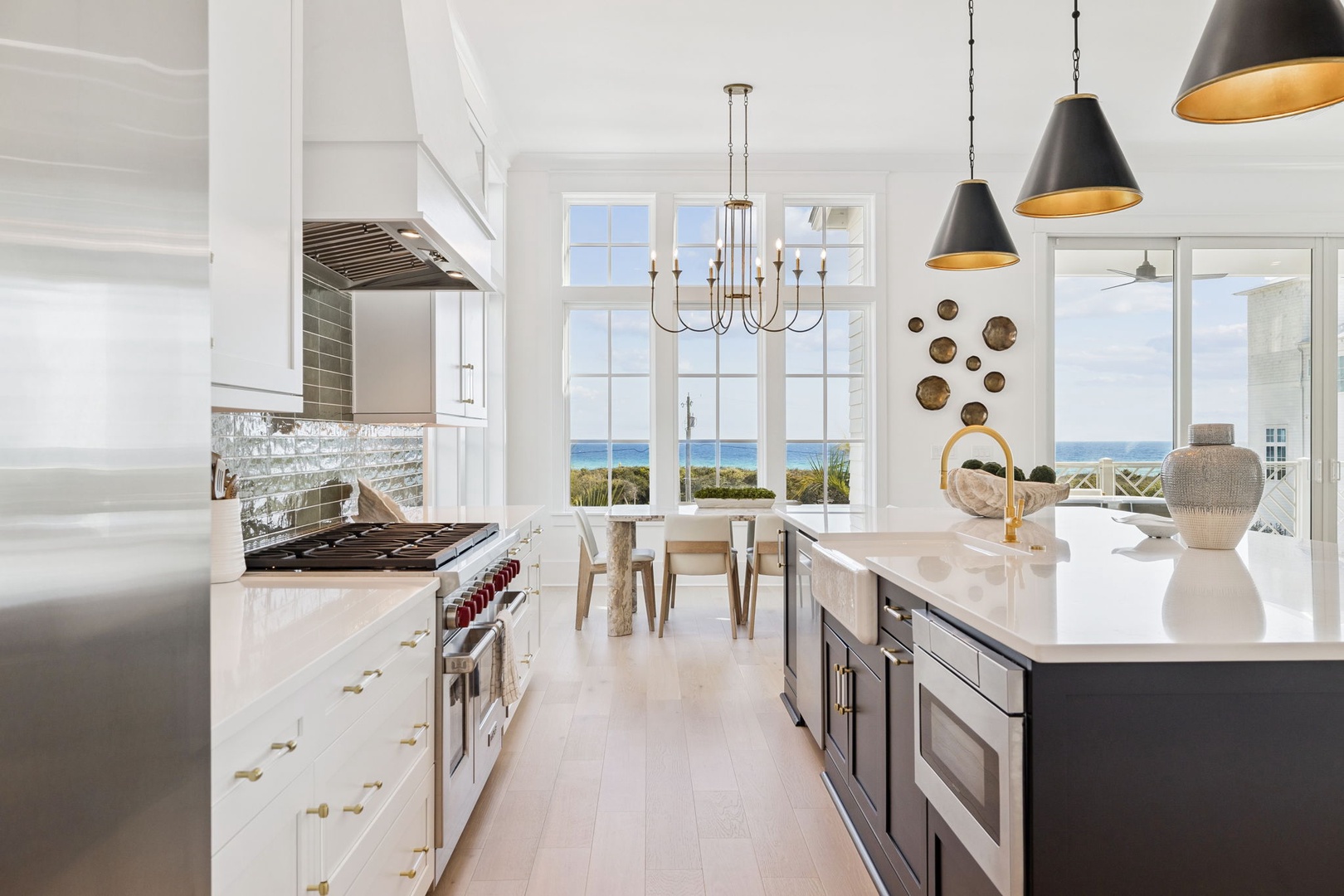 Your gourmet kitchen opens to stunning ocean views, where culinary adventures meet coastal serenity through expansive windows.
