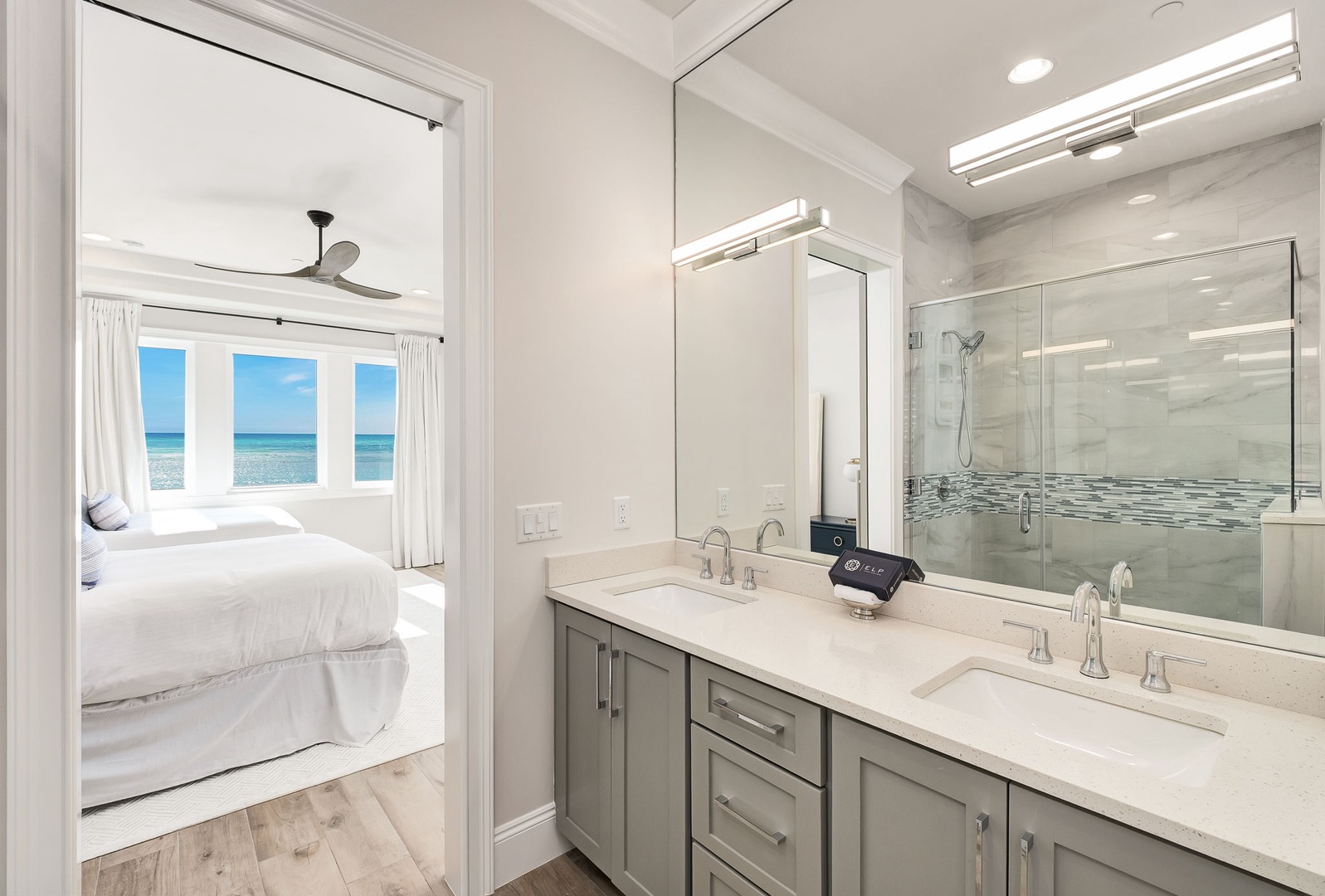 Wake up to ocean views from your spacious bedroom, then refresh in this elegant ensuite with dual vanities and luxurious finishes.