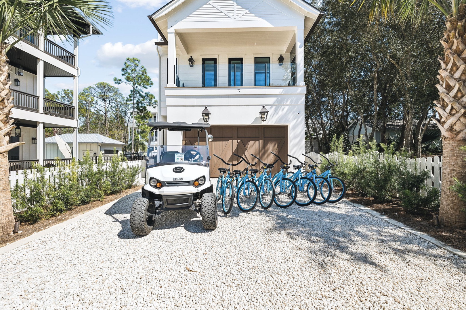 Coastal charm welcomes you home with a collection of bikes waiting to explore the neighborhood and a convenient golf cart to take you wherever the day leads.