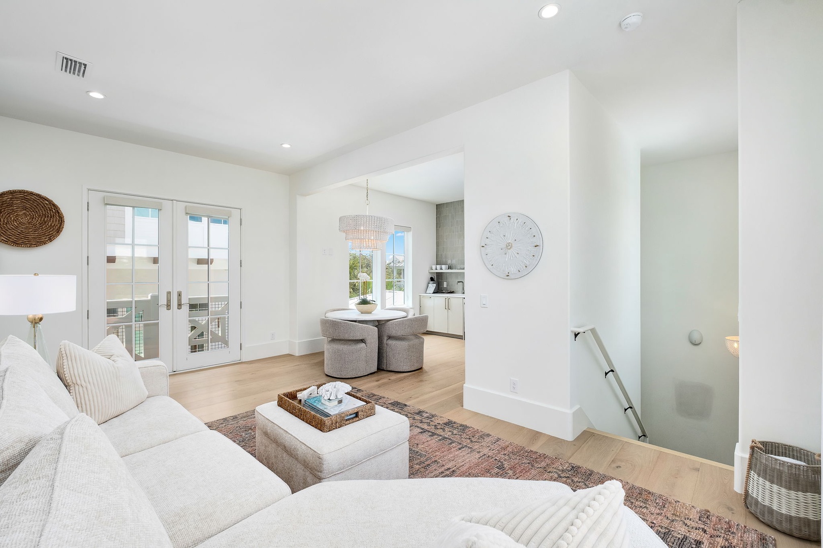 Step into your bright, open-concept living space where soft textures and coastal tones welcome you home. Doors open to your private outdoor space—perfect for sipping morning coffee or unwinding as the day ends.