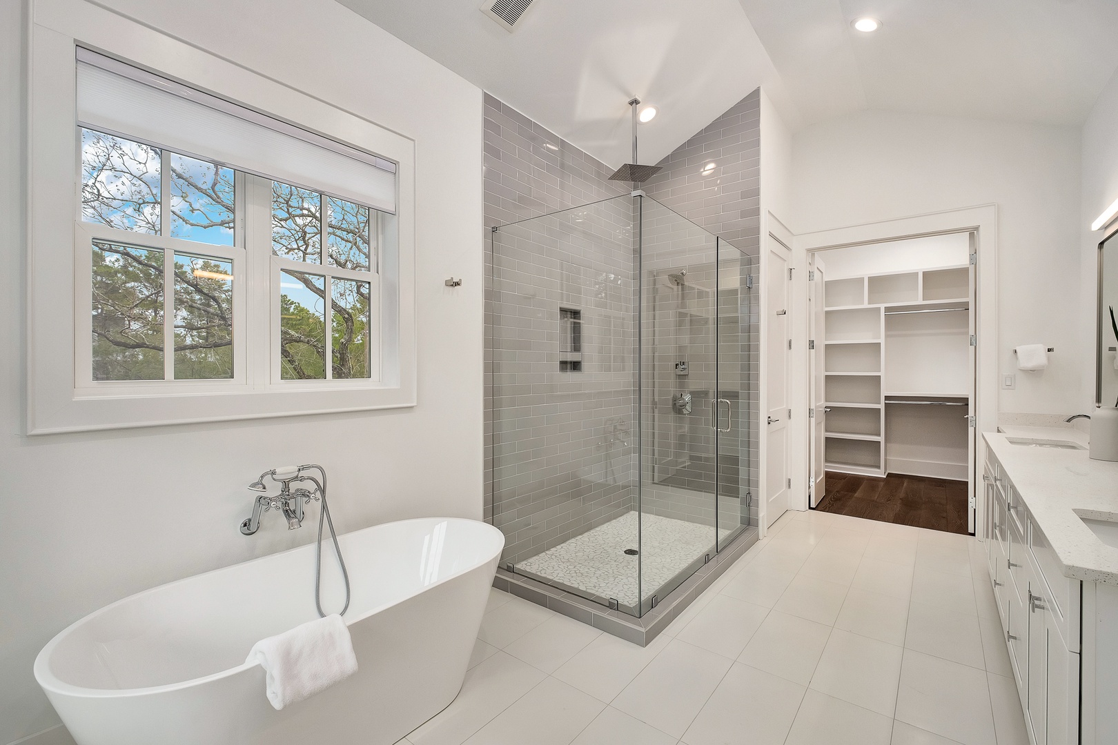 Unwind in your spa-like master bathroom with a dreamy soaking tub and spacious glass shower.